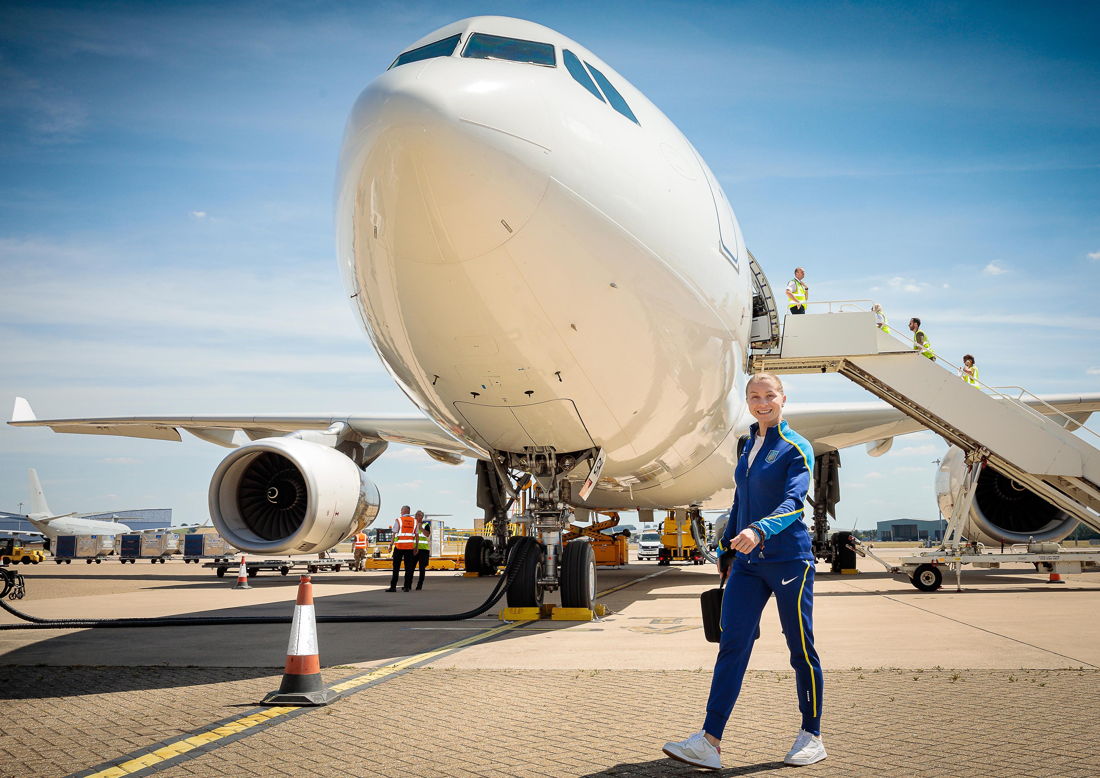 Image shows Games athlete walking past a RAF Voyager on the airfield.