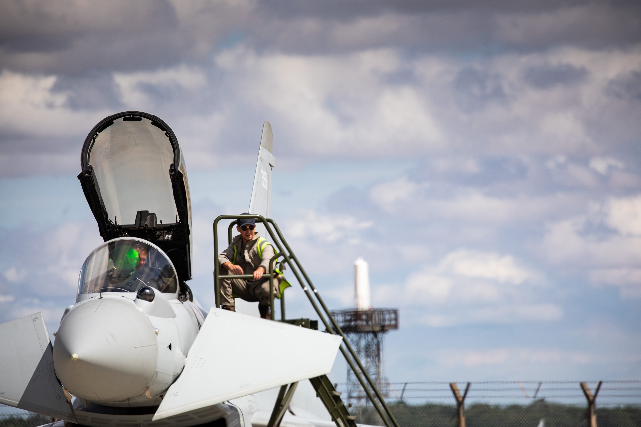 Image shows RAF Pilots with Typhoon on the airfield.