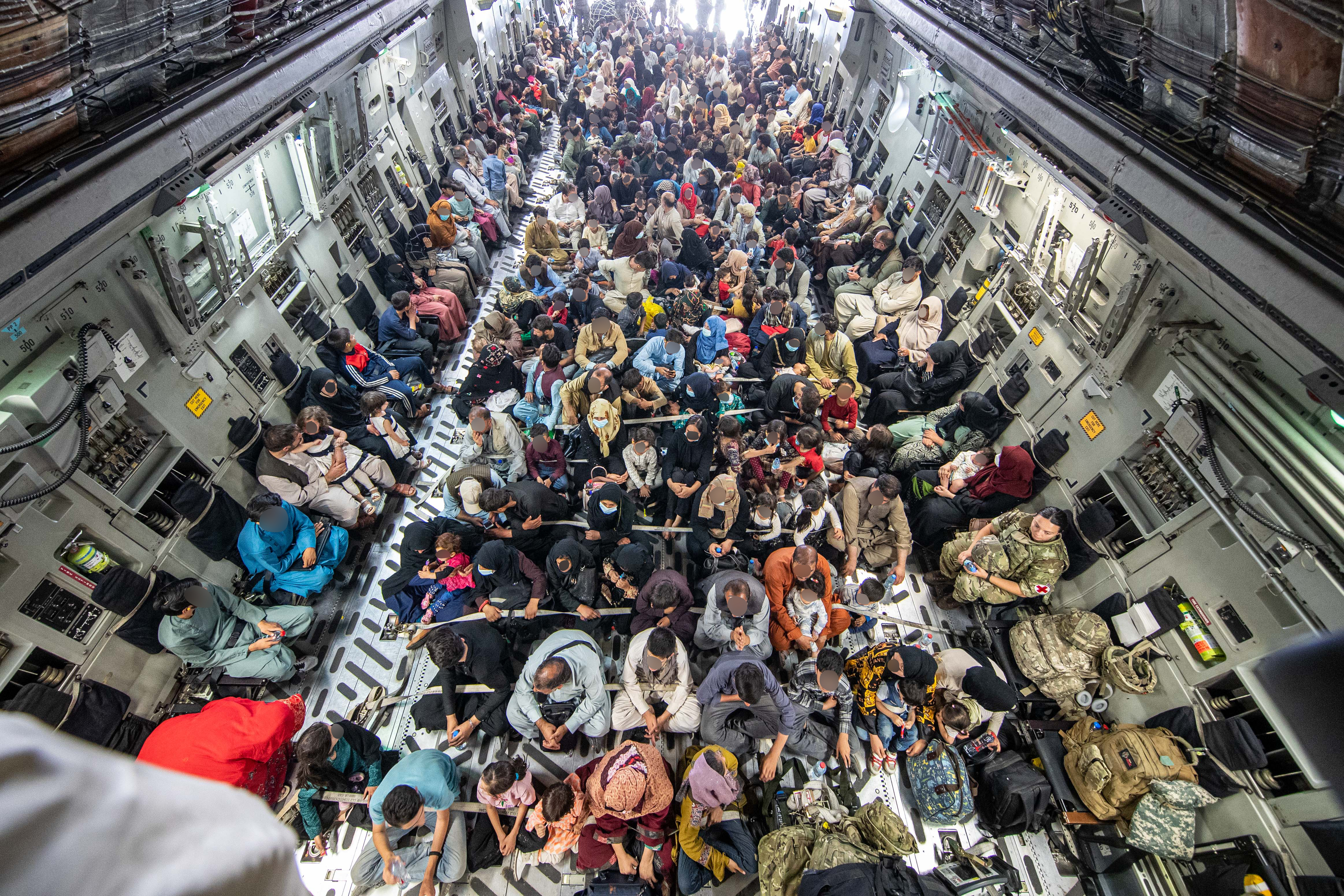 Afghan evacuees and personnel inside the Globemaster C-17.