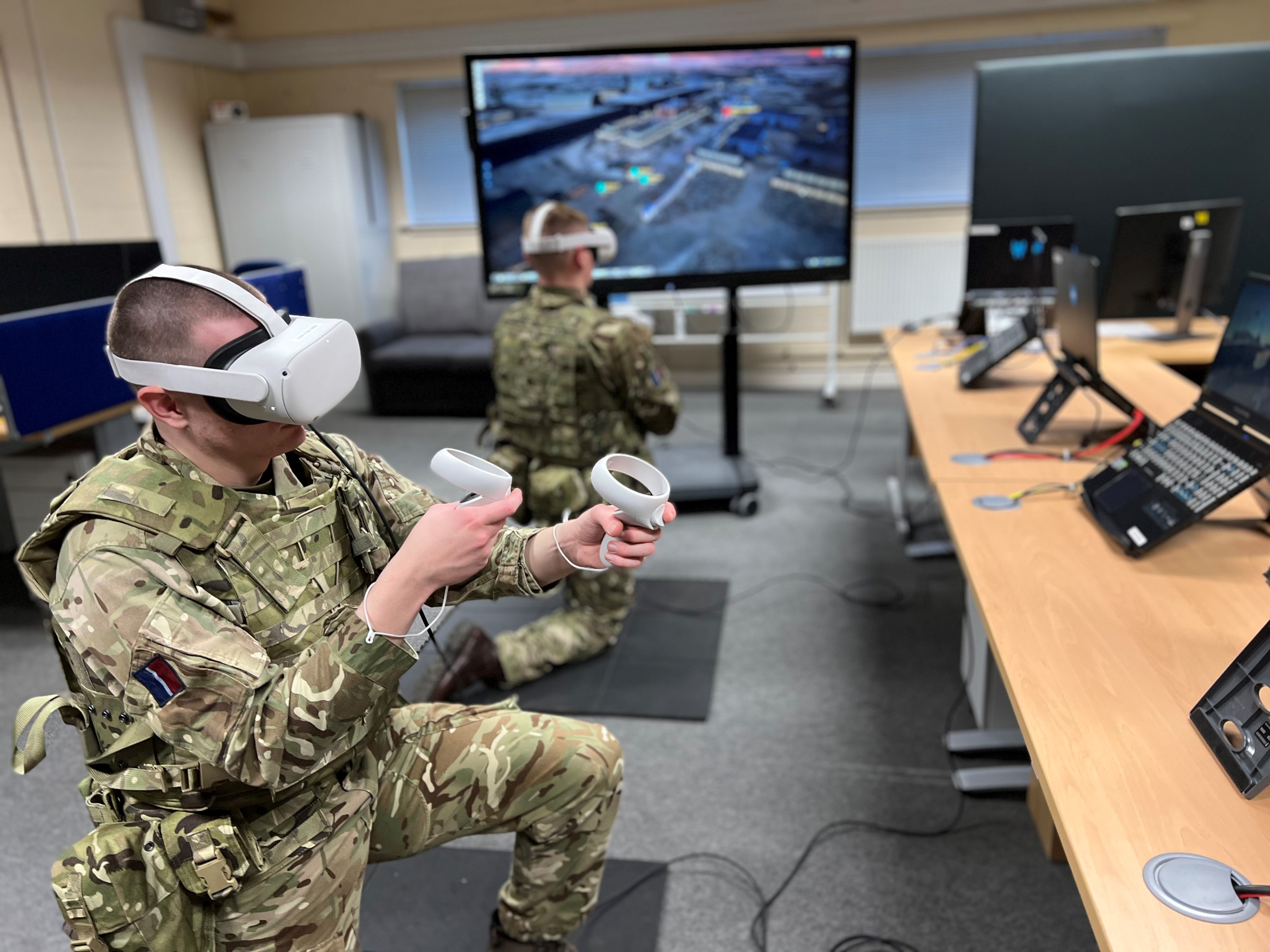 Personnel wear Virtual Reality headsets and use equipment.
