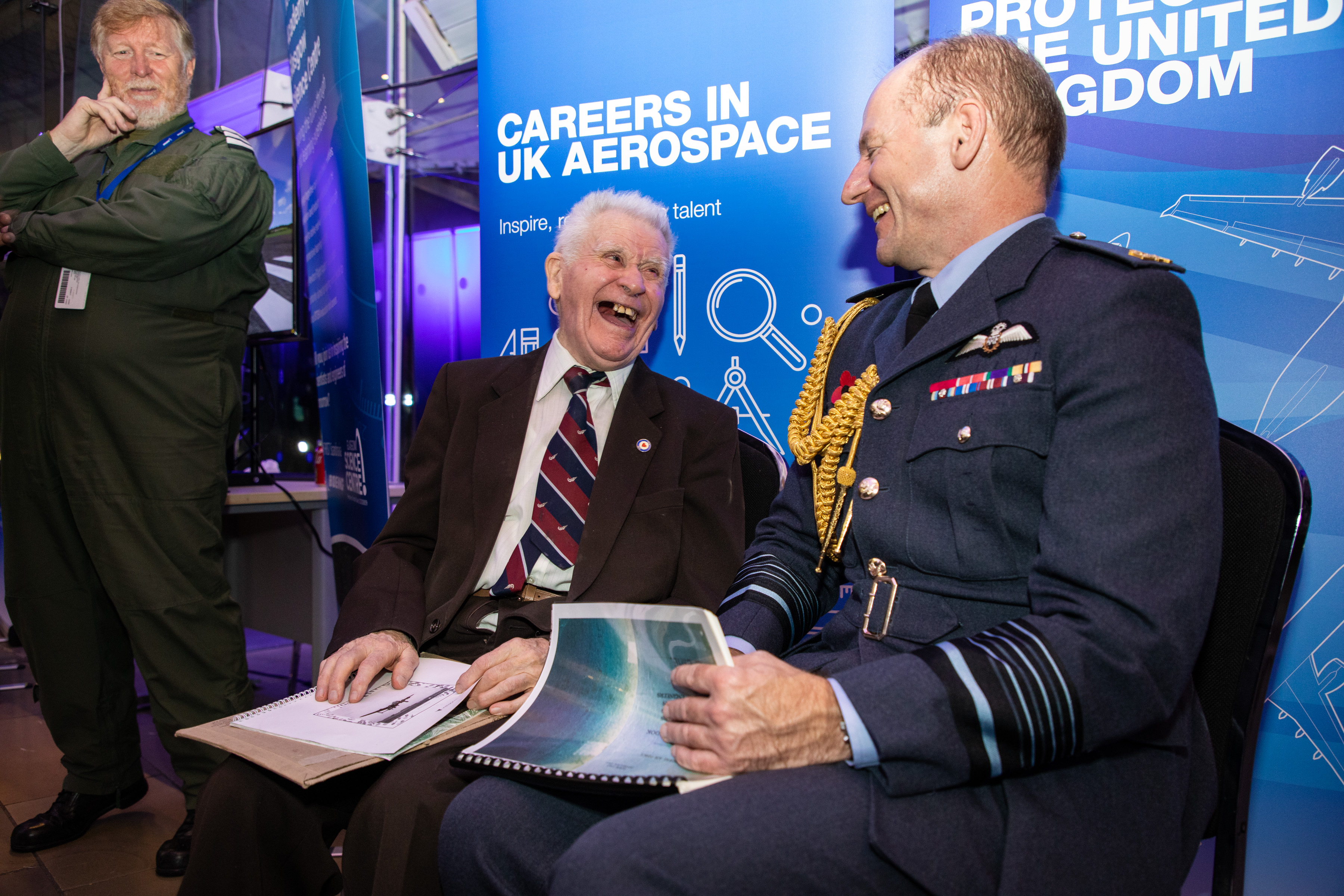 Air-Vice Marshal Sir Mike Wigston laughs with veteran.