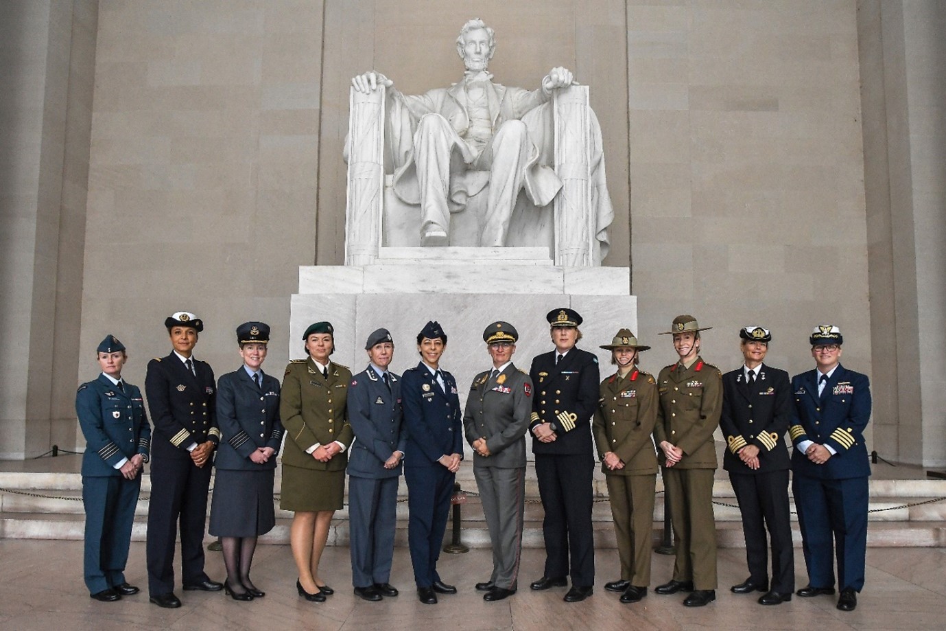 Image shows personnel standing by statue of Abraham Lincoln at Washington DC.