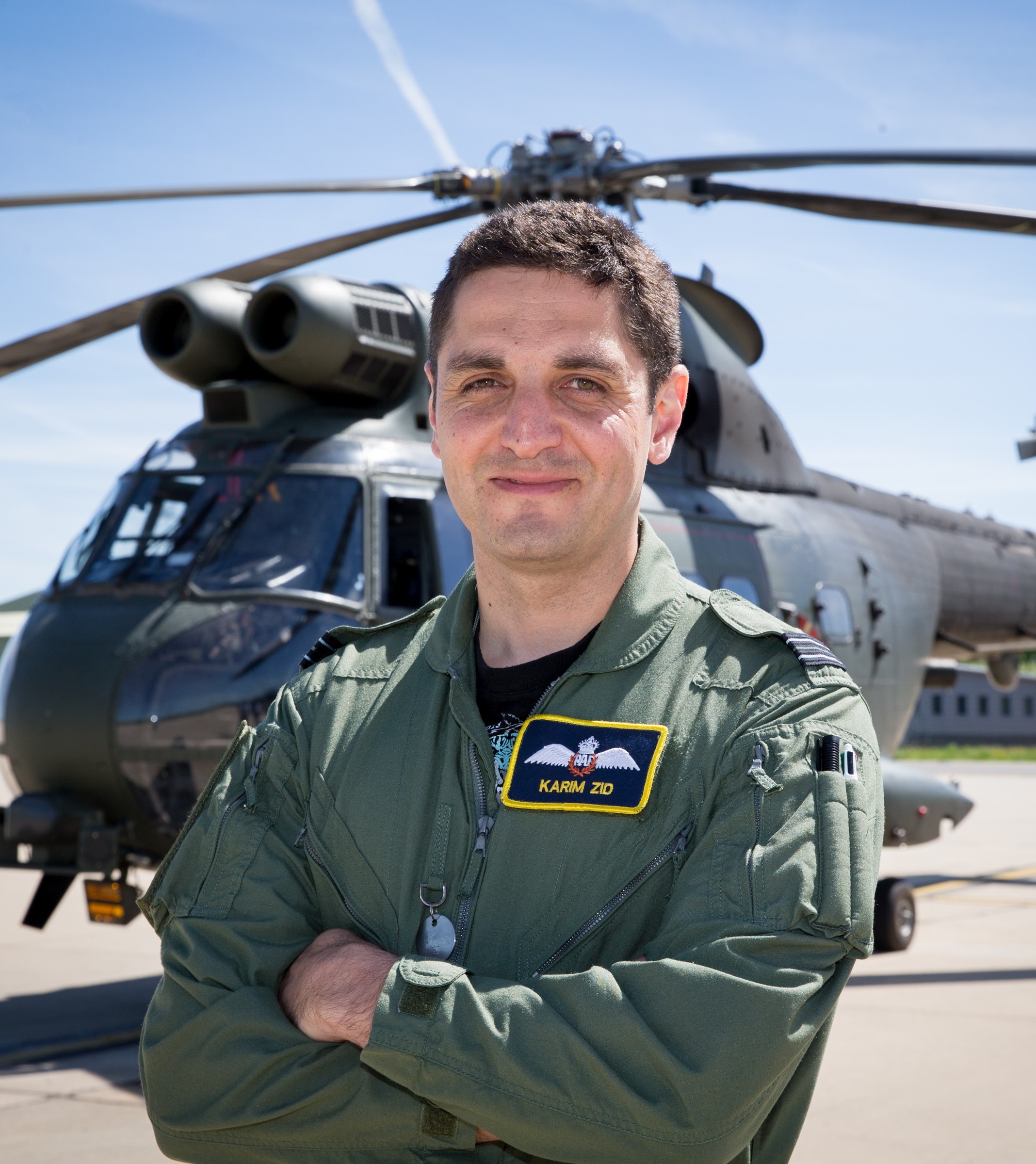 Sqn Leader Karim Zid stood in front of a Puma helicopter.