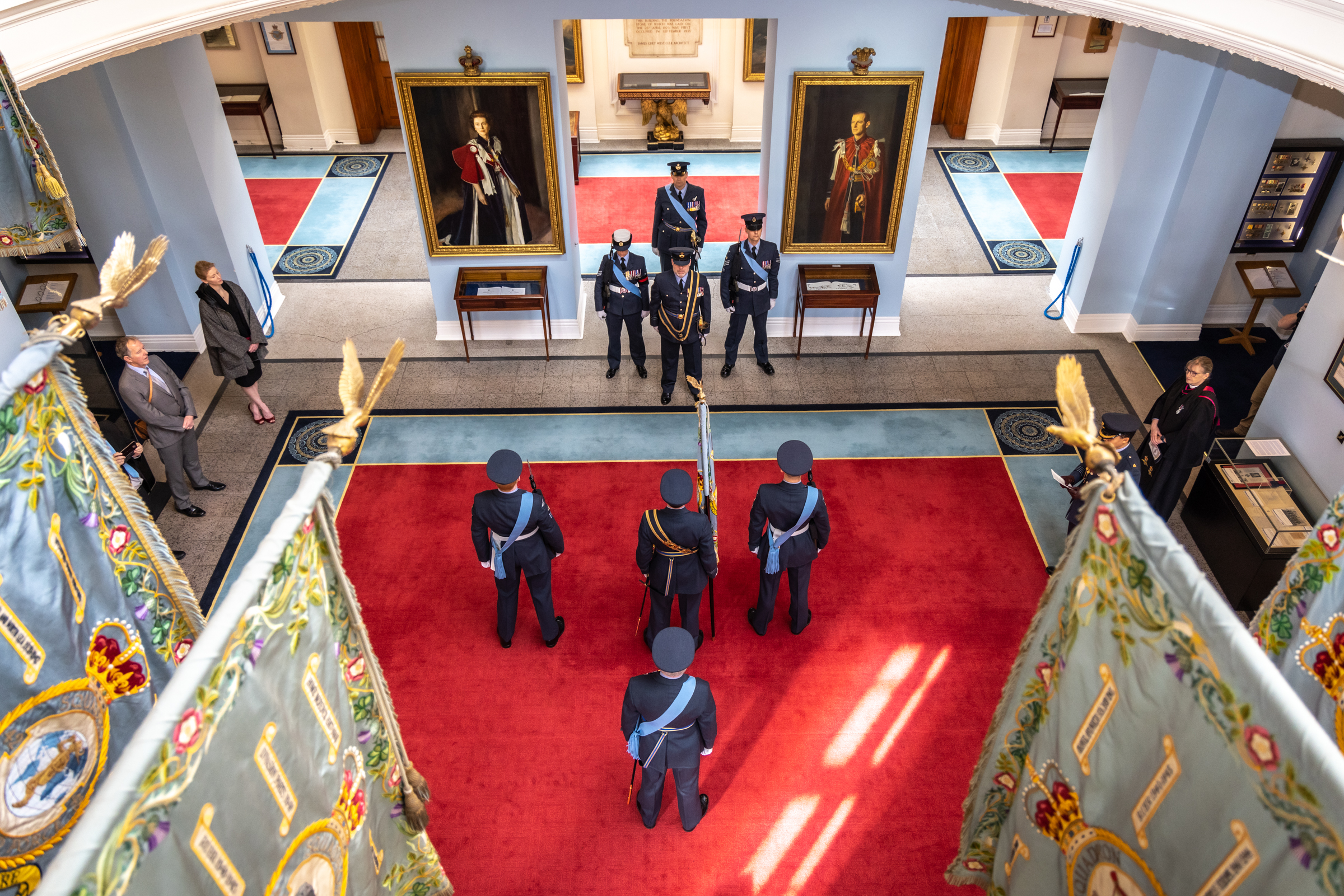 Image shows above shot of RAF aviators standing inside Officers' Mess during ceremony.