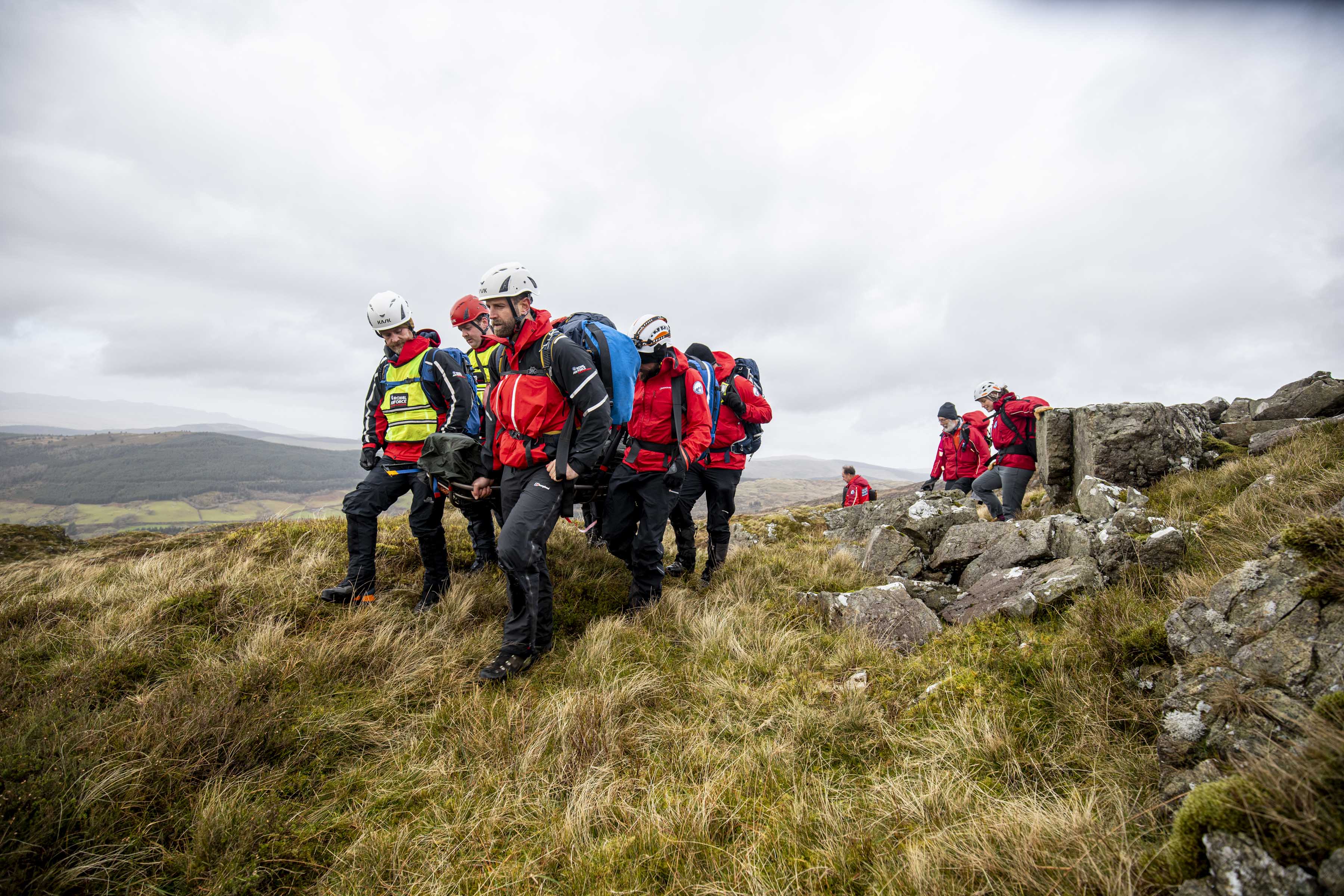 Image shows Search and Rescue team on mountain.