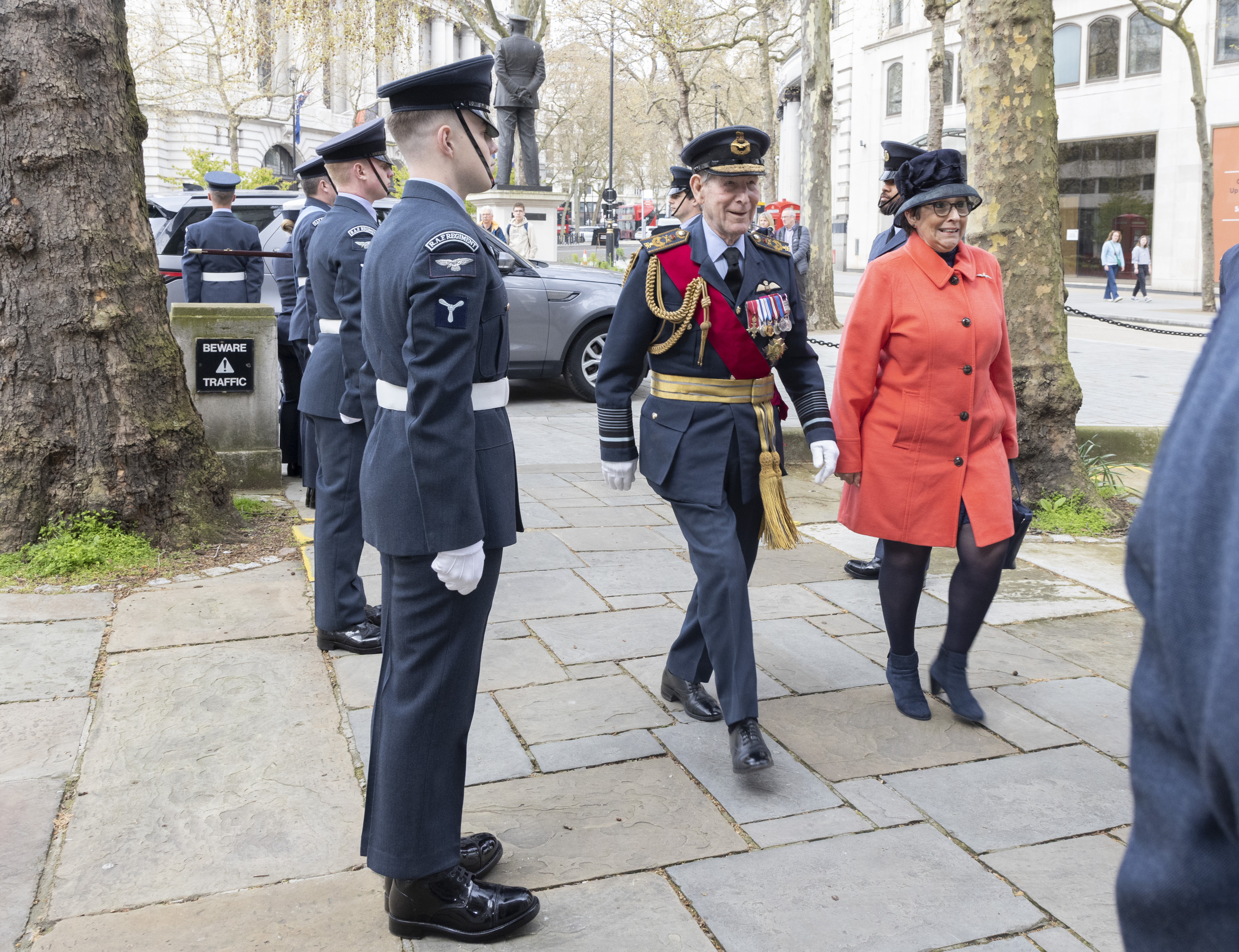 Image shows Personnel walking between RAF personnel in the street.