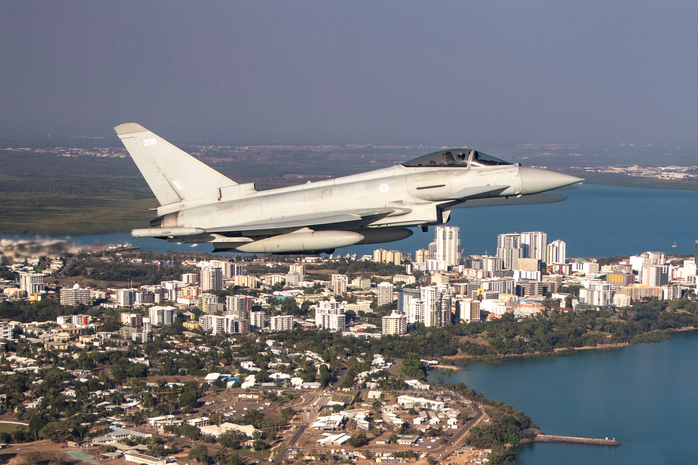 Image of a RAF Typhoon in flight over coastal town.