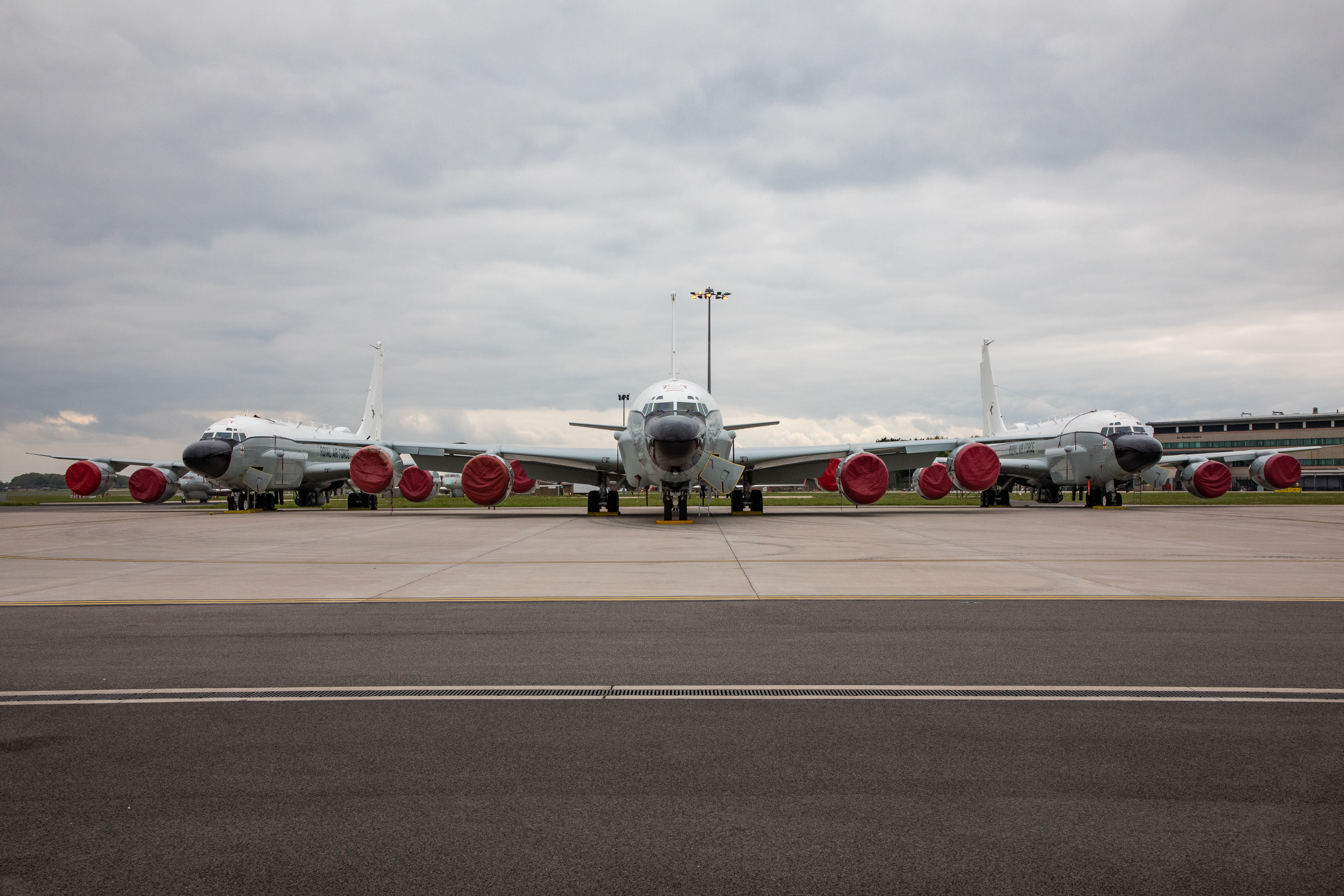 Three RC-135W Rivet Joint aircraft on the airfield.