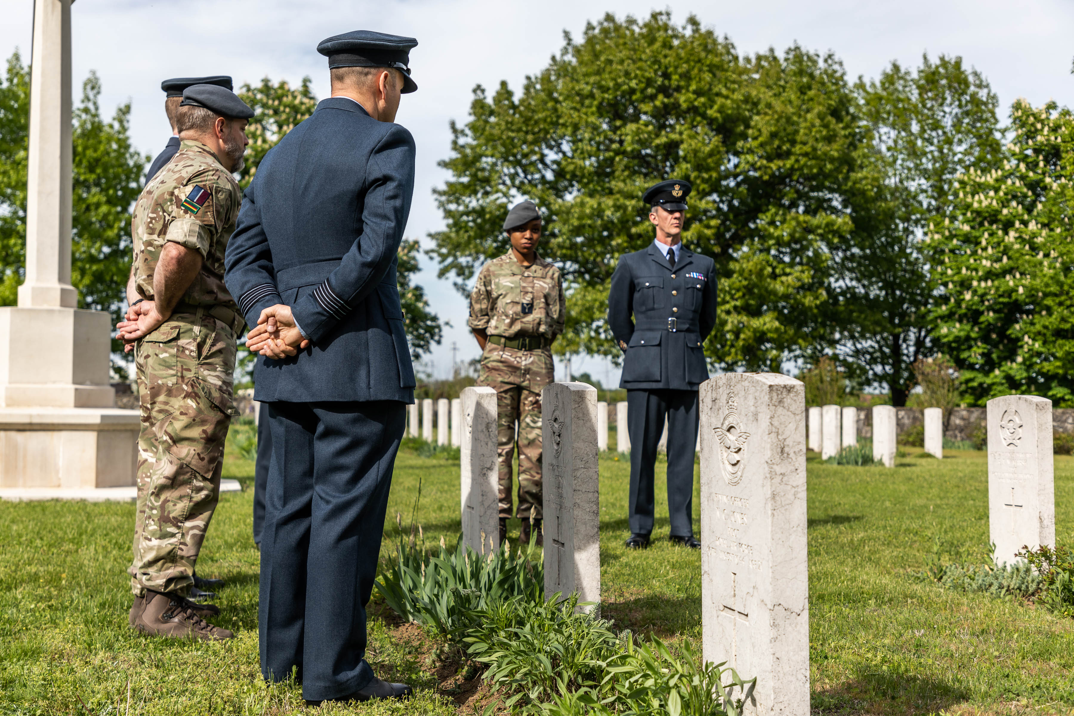 Personnel looks towards cemetery headstones.
