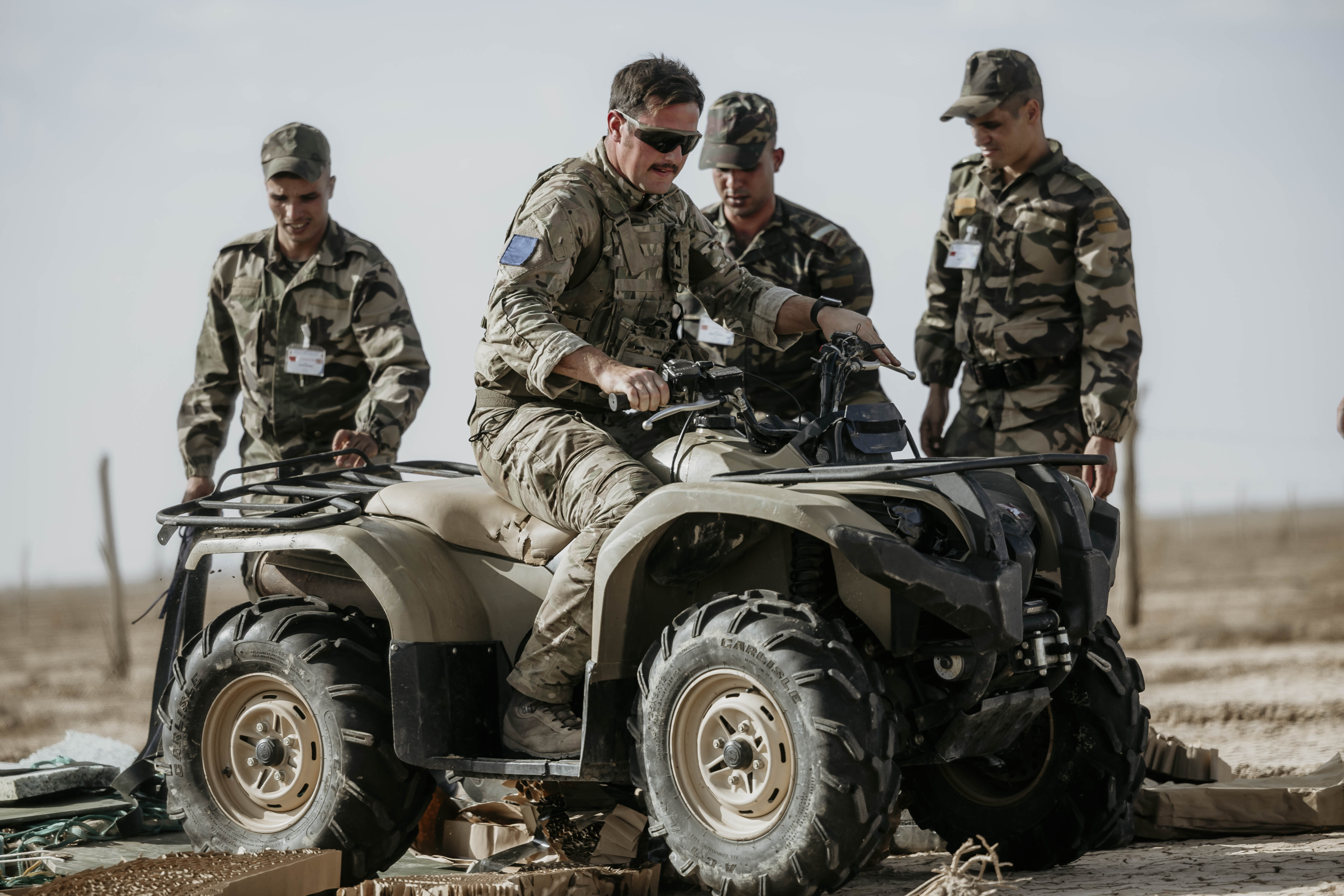 Image shows RAF aviators with a jeep vehicle.