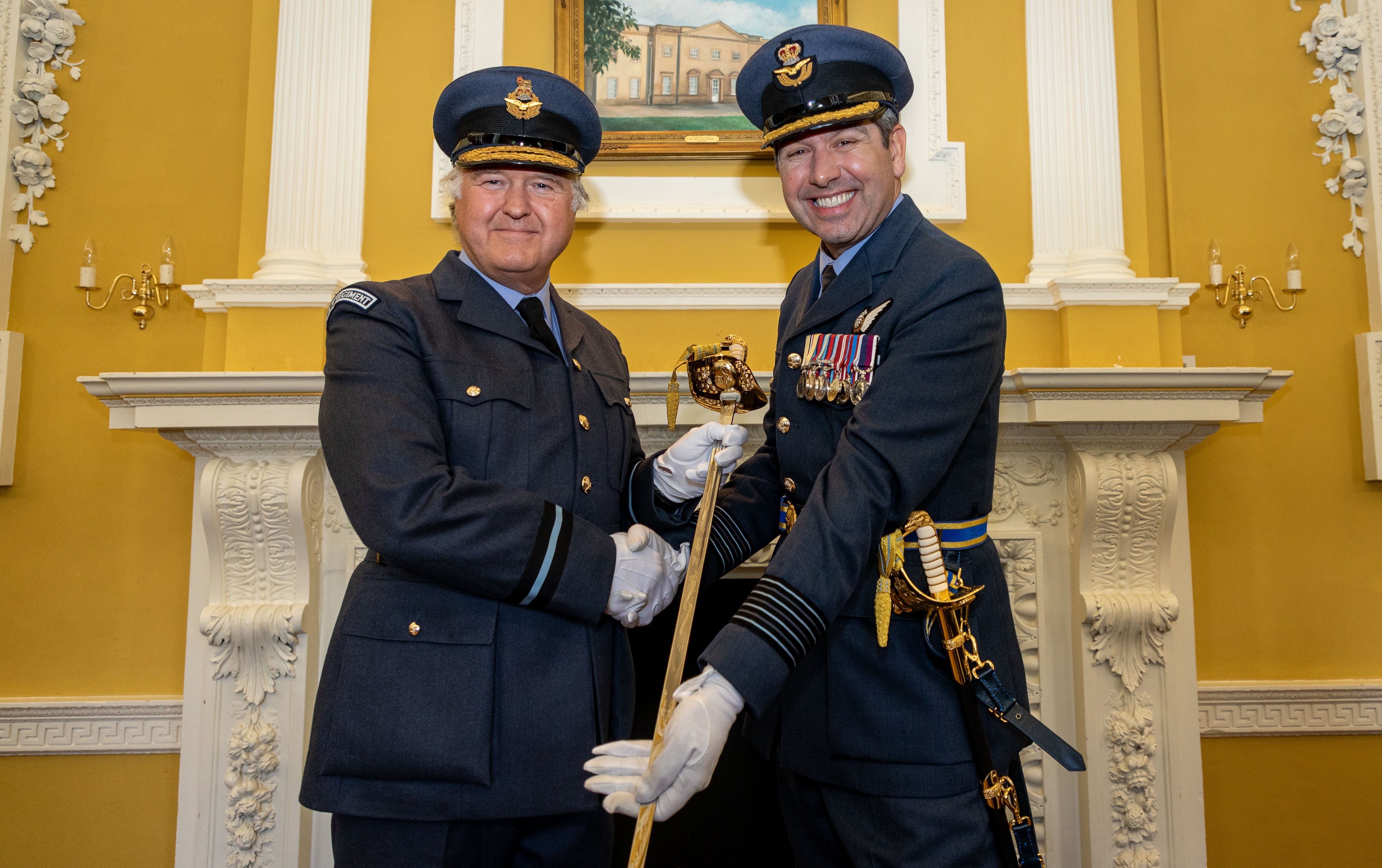Image shows RAF aviators holding the Firmin Sword.