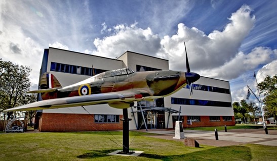 Image shows a model Spitfire outside RAF Northolt building.