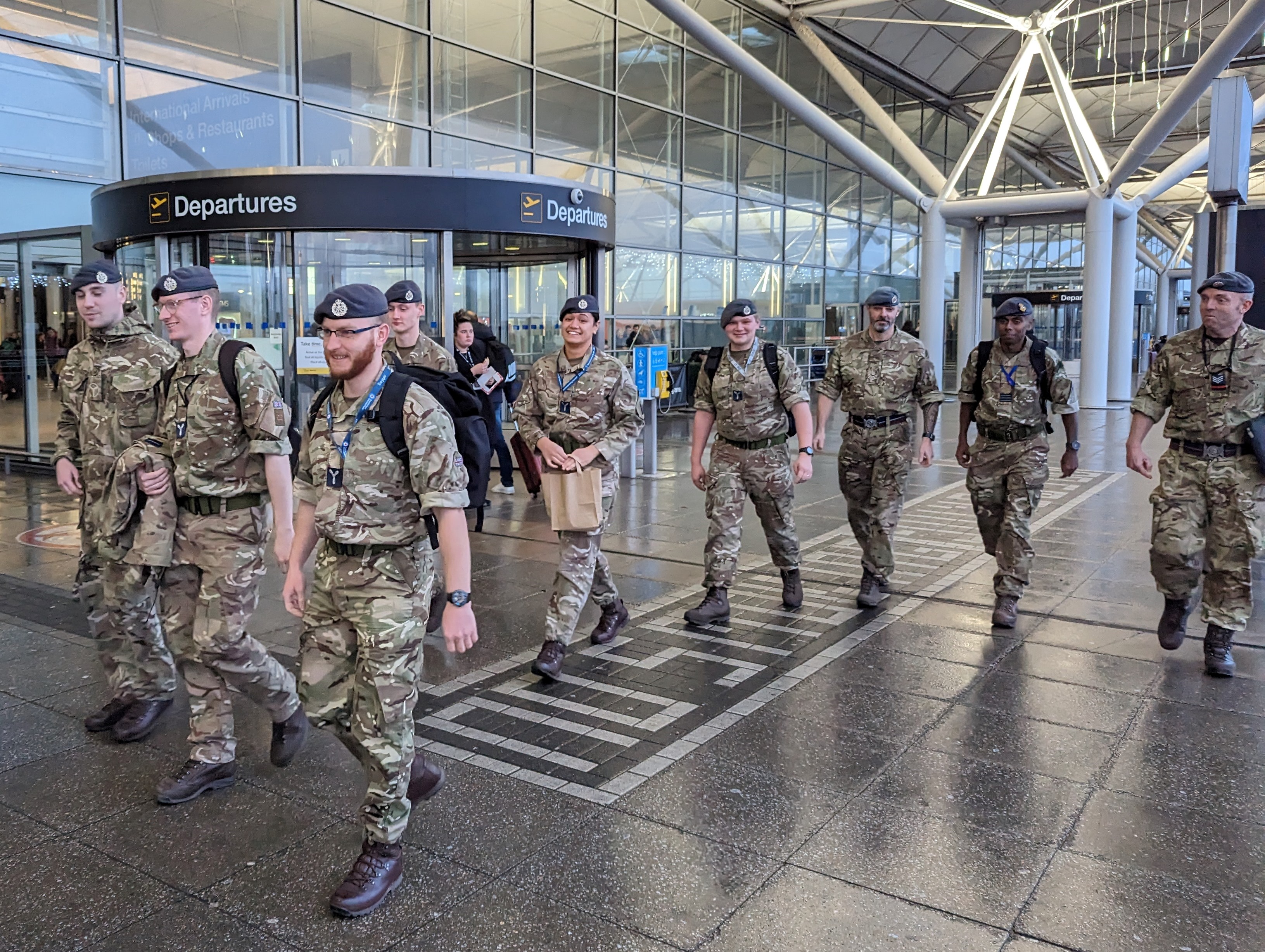 Image shows RAF Aviators walking past departures at Stansted Airport.