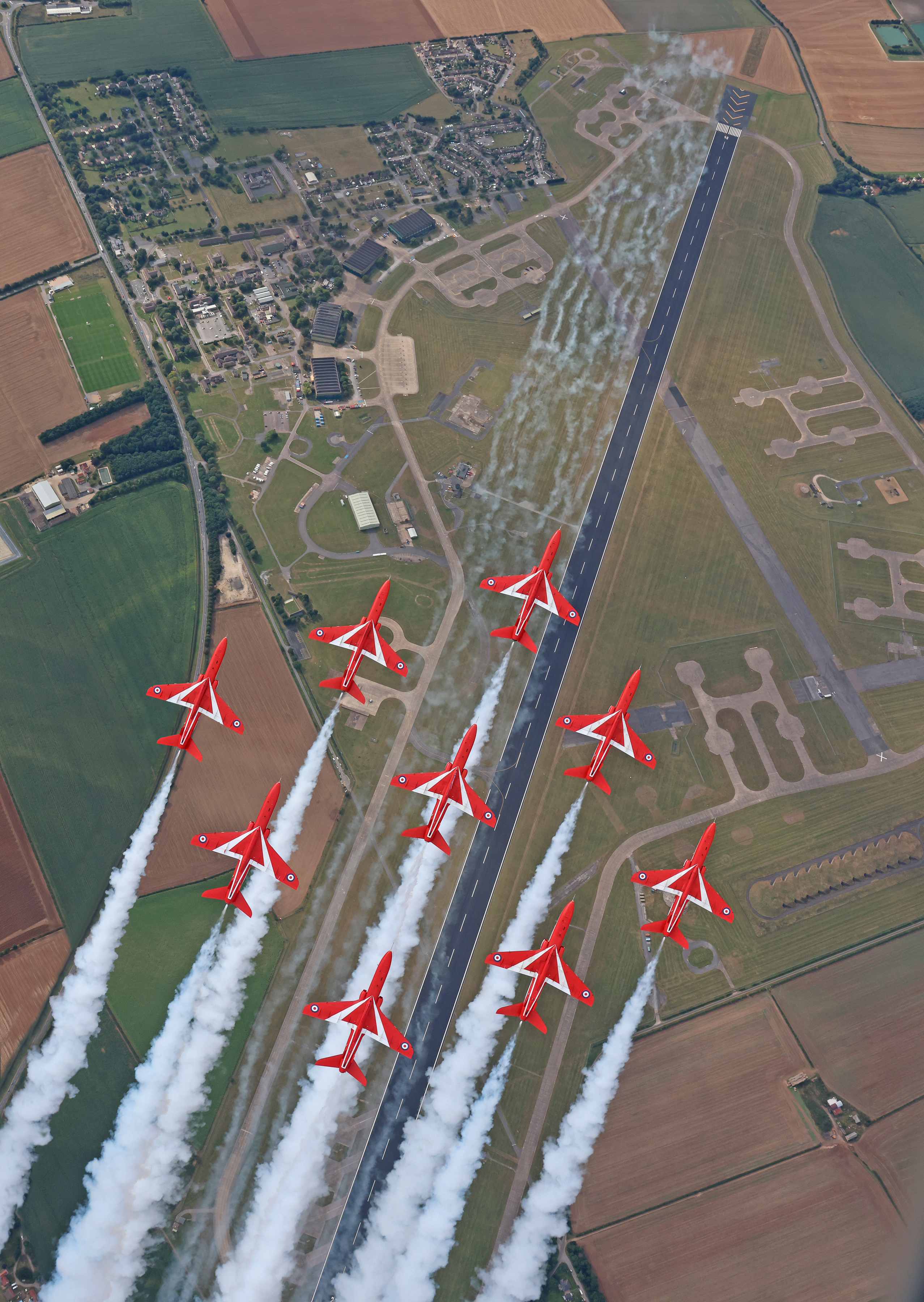 The Red Arrows, in Diamond Nine formation, over RAF Scampton.