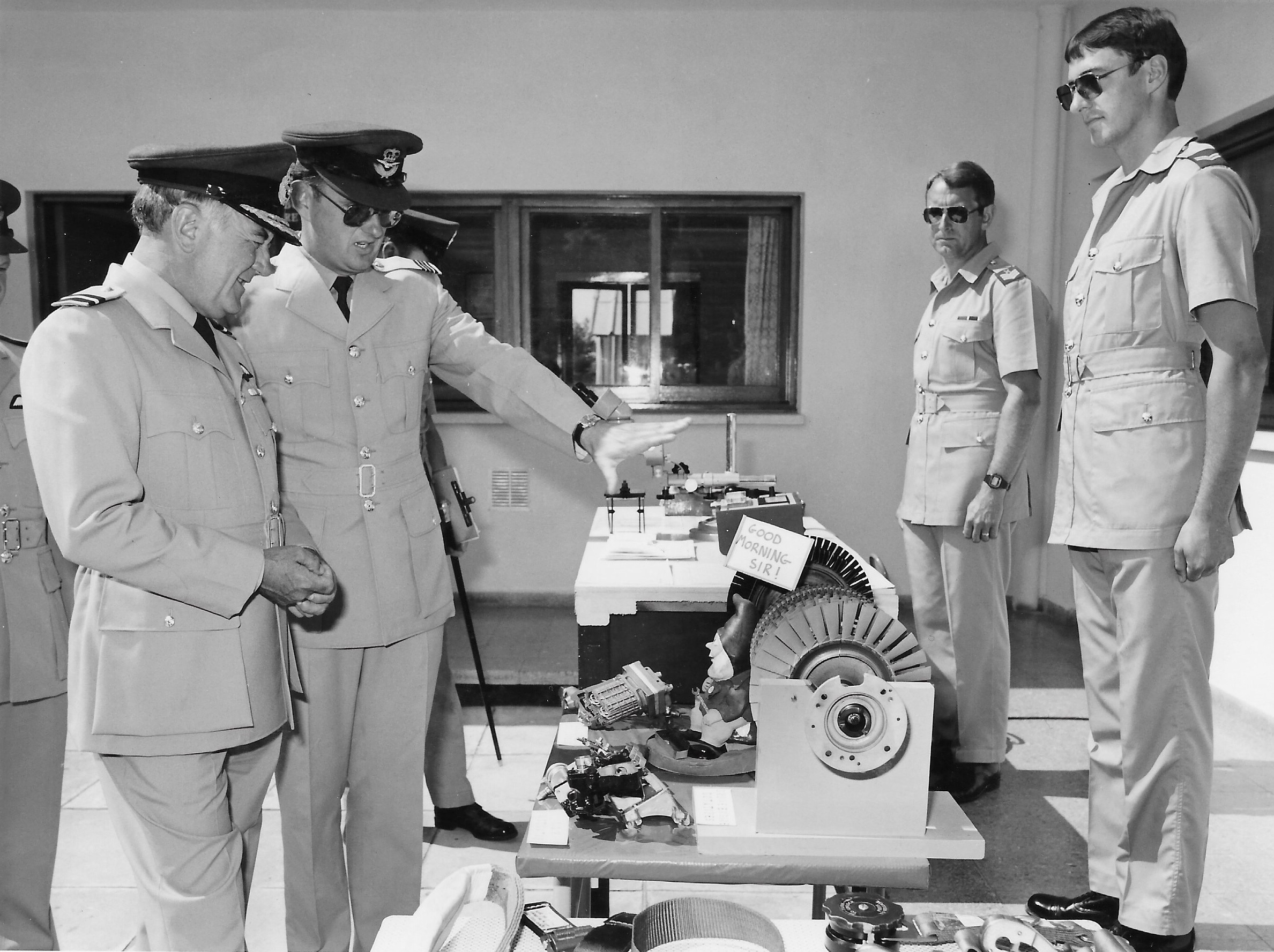 Black and white image shows Image shows RAF Aviators during inspection. 