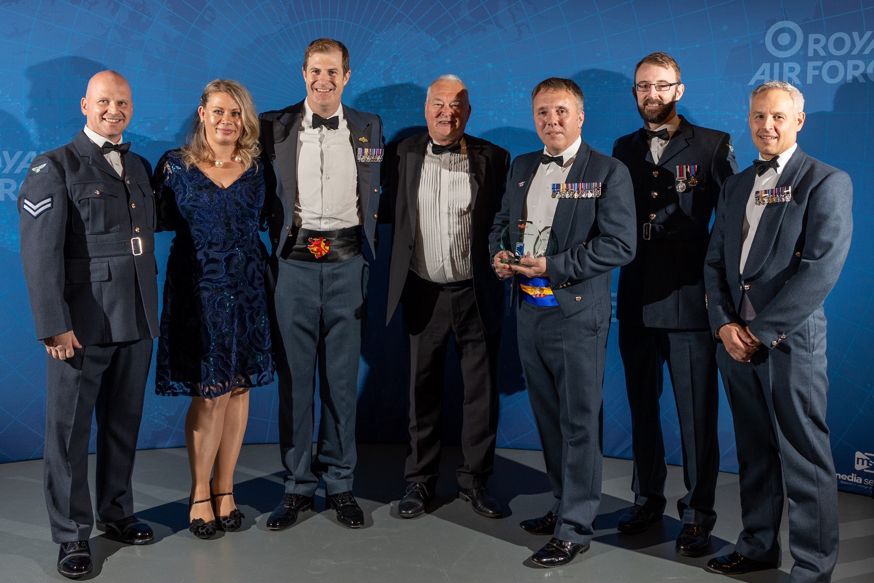 Image shows RAF aviators posing for picture at awards ceremony.