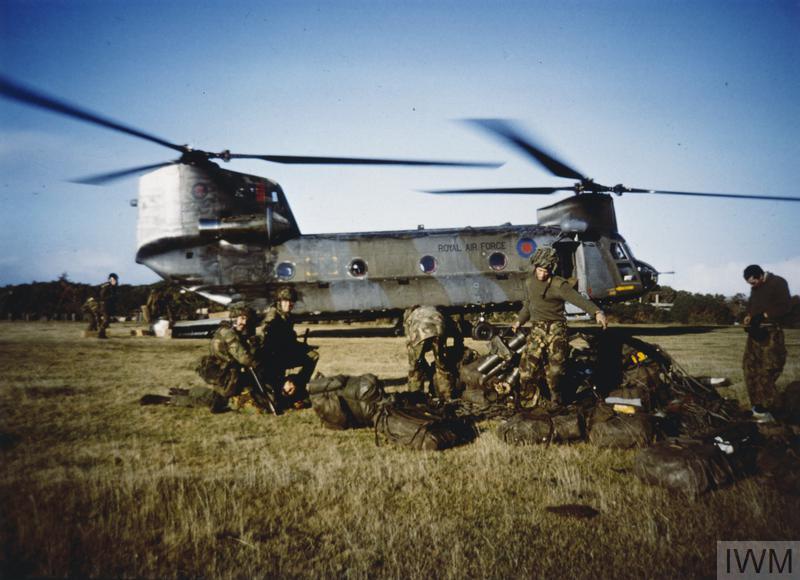 Old photo of a Chinook and RAF personnel on the ground.