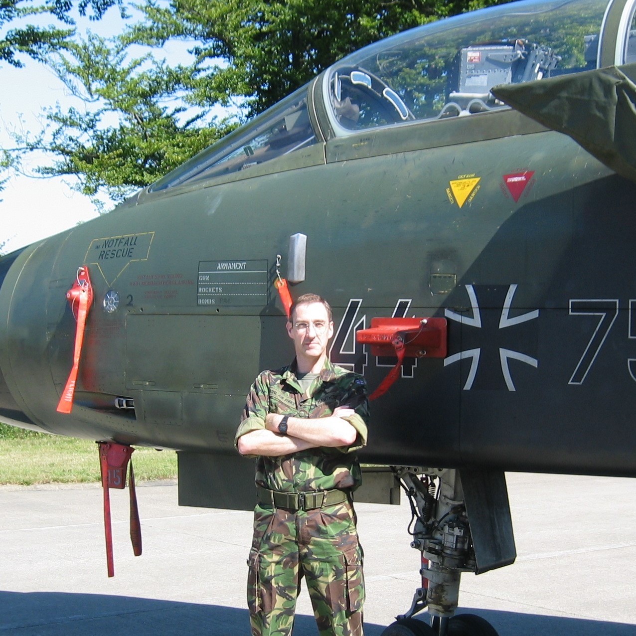 Archived image shows RAF Aviator standing cross armed next to a grounded aircraft.
