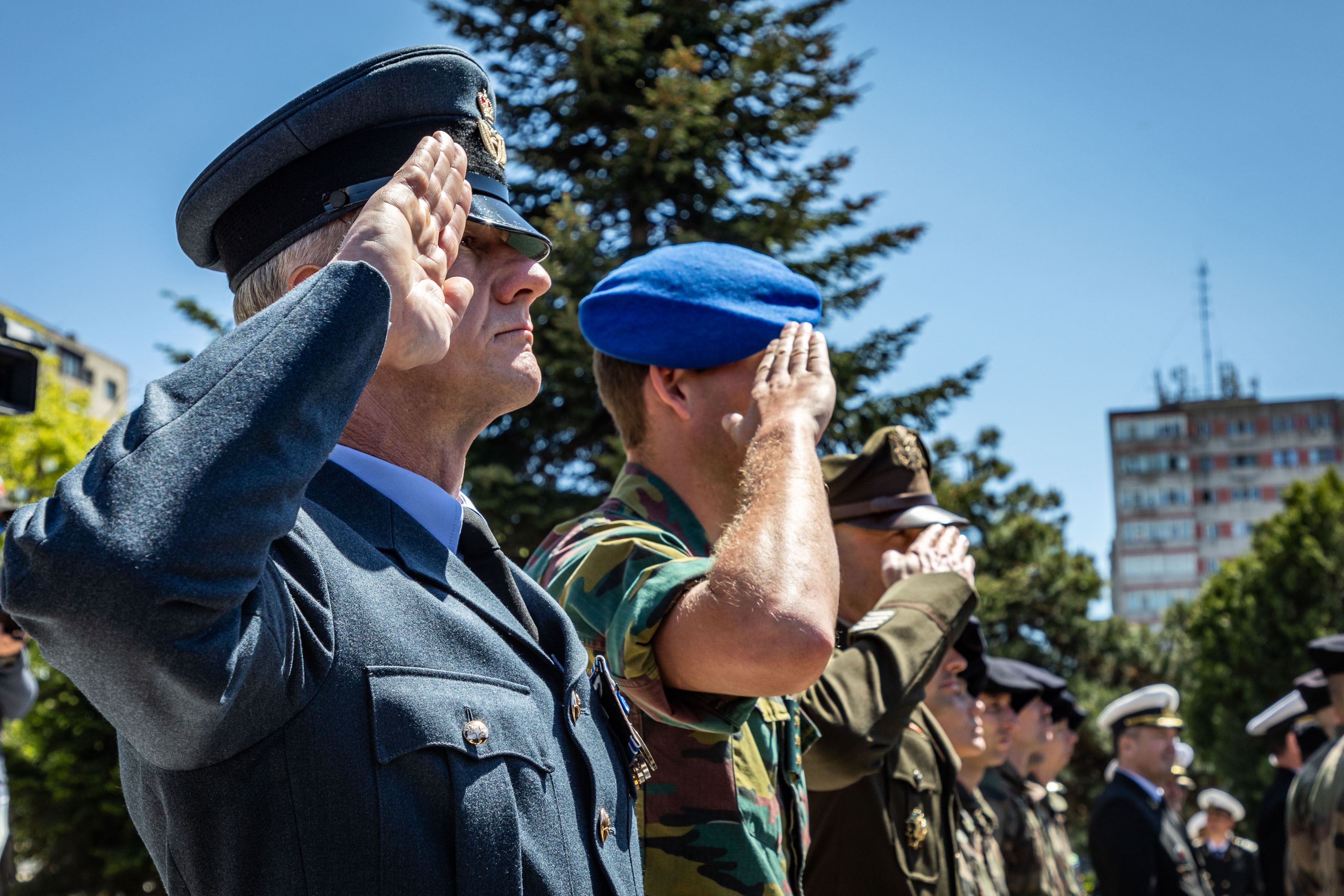 RAF Personnel salutes with Romanian allies.