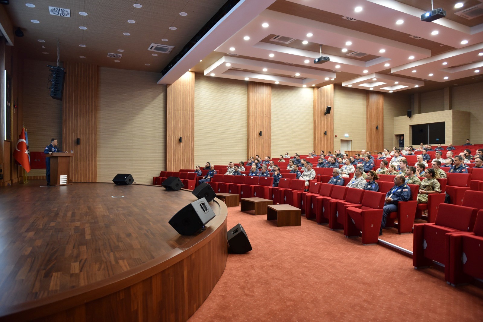 Image shows personnel inside lecture room.