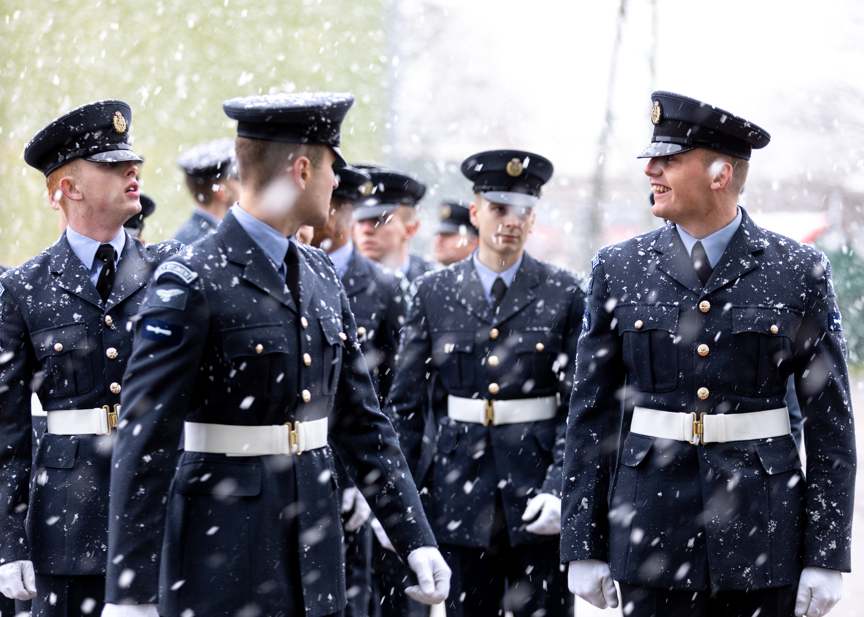 Graduates finish their parade just in time as the wintry showers increase