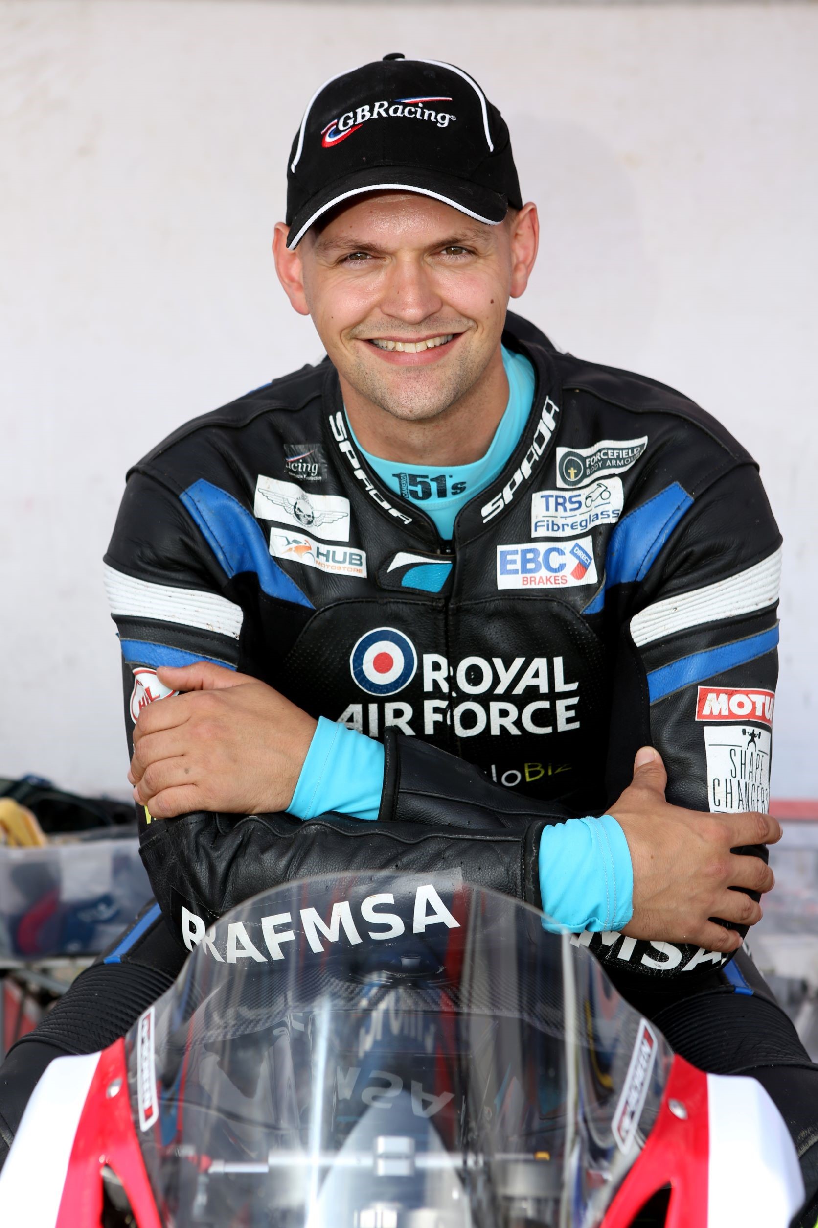 Image shows an RAF aviator in Motorbike gear while sitting on a motorcycle.