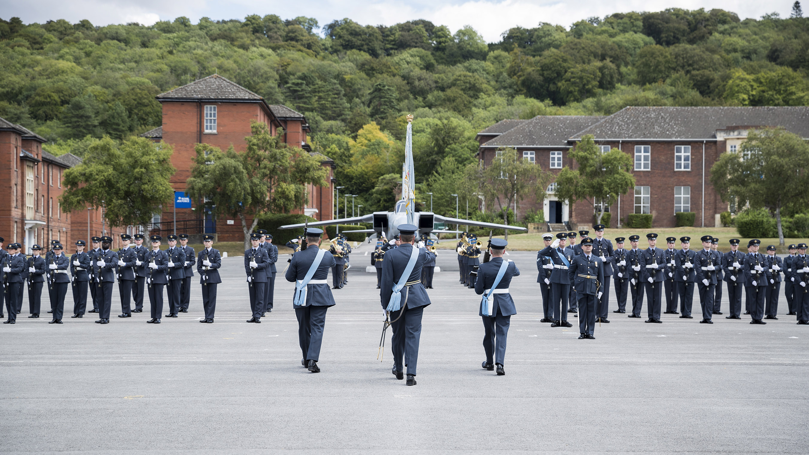 Personnel on parade with model Hawker Hunter on the parade square.