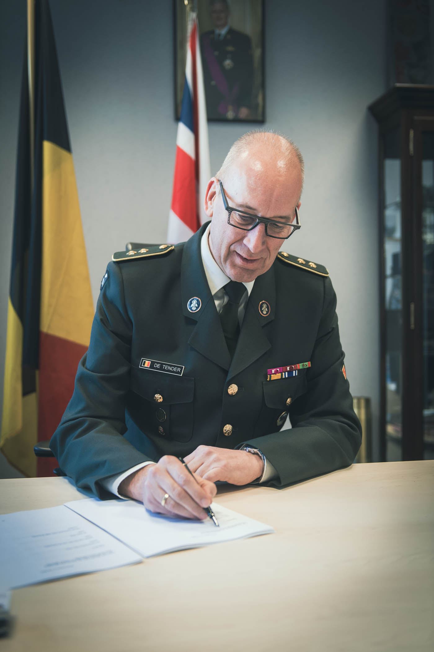 Image shows Belgian Air Force personnel signing agreement.