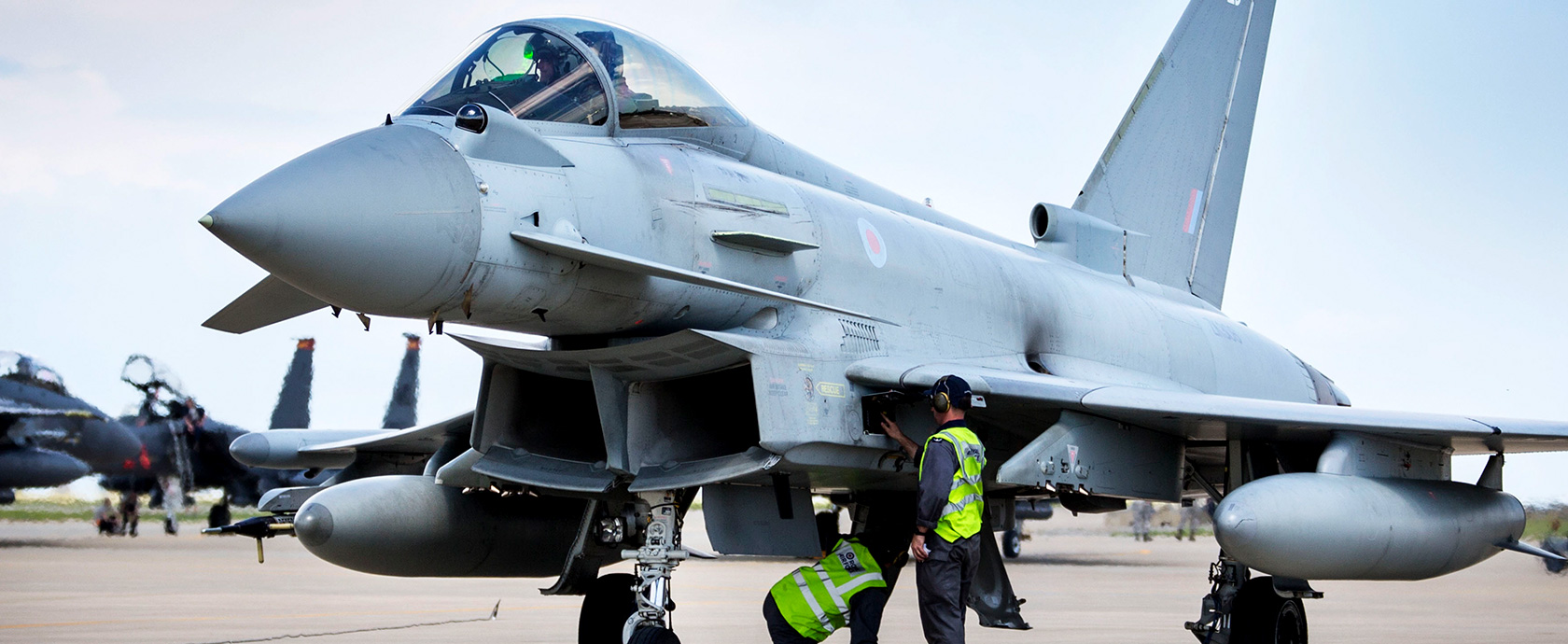 Image shows RAF Typhoon on the airfield with RAF aviator.