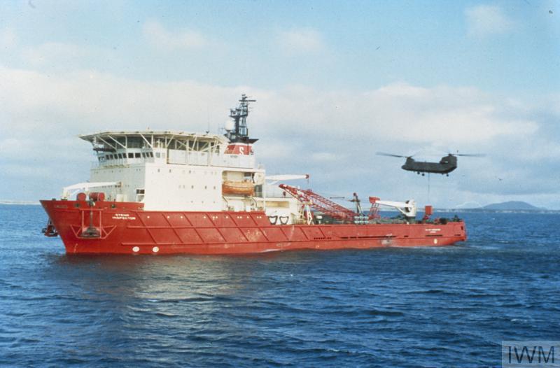 Aged image of Ship with helicopter flying past.