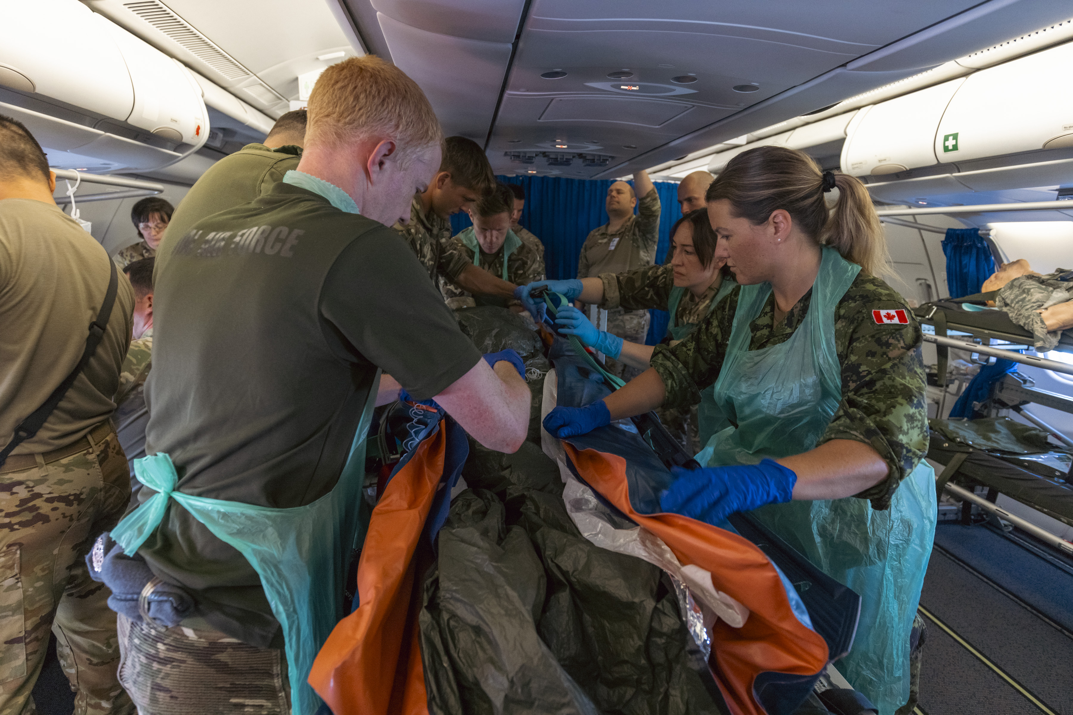Colleagues from multiple nations working on a med exercise onboard an RAF Voyager
