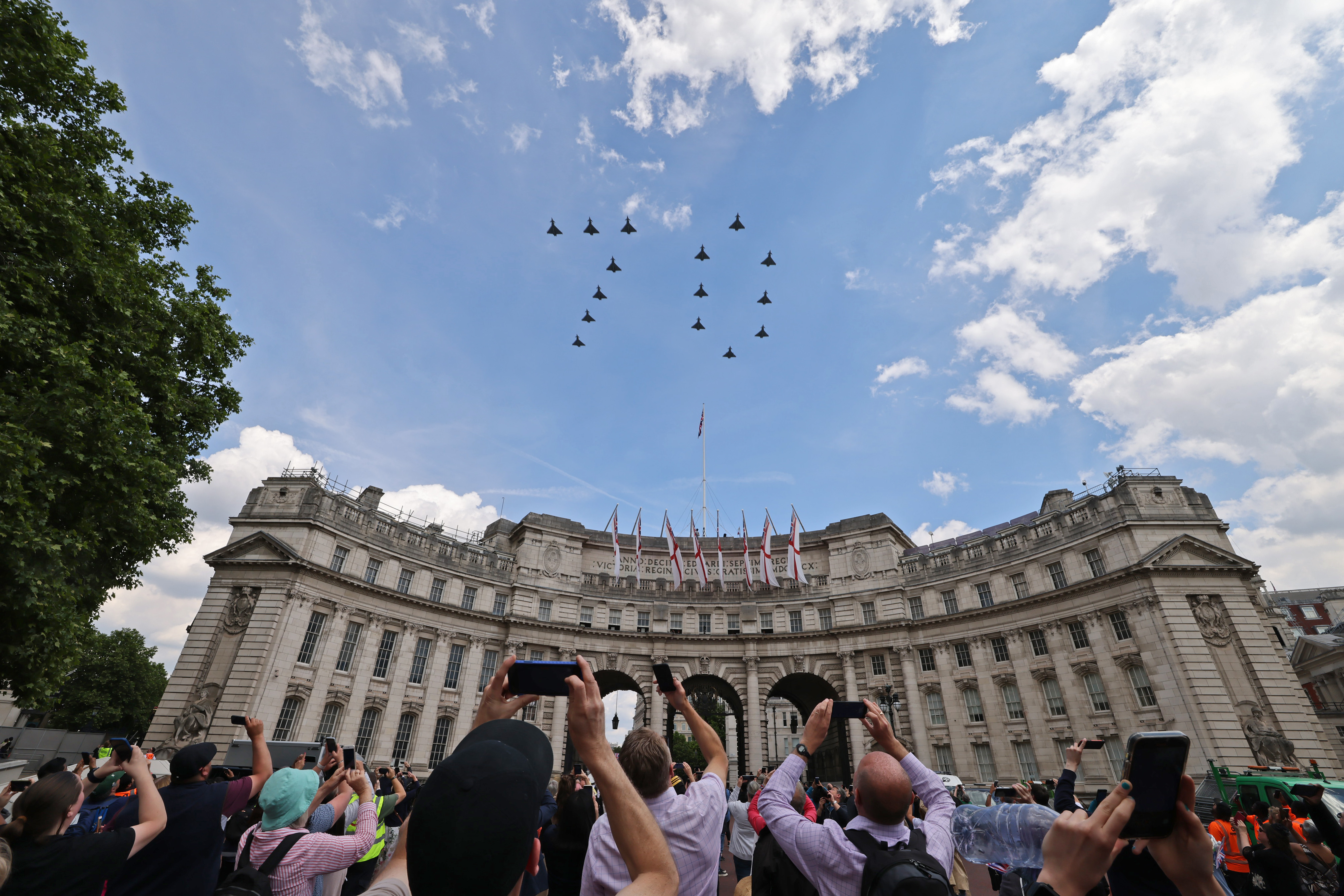 Crowd look up to flypast in a 70 formation.