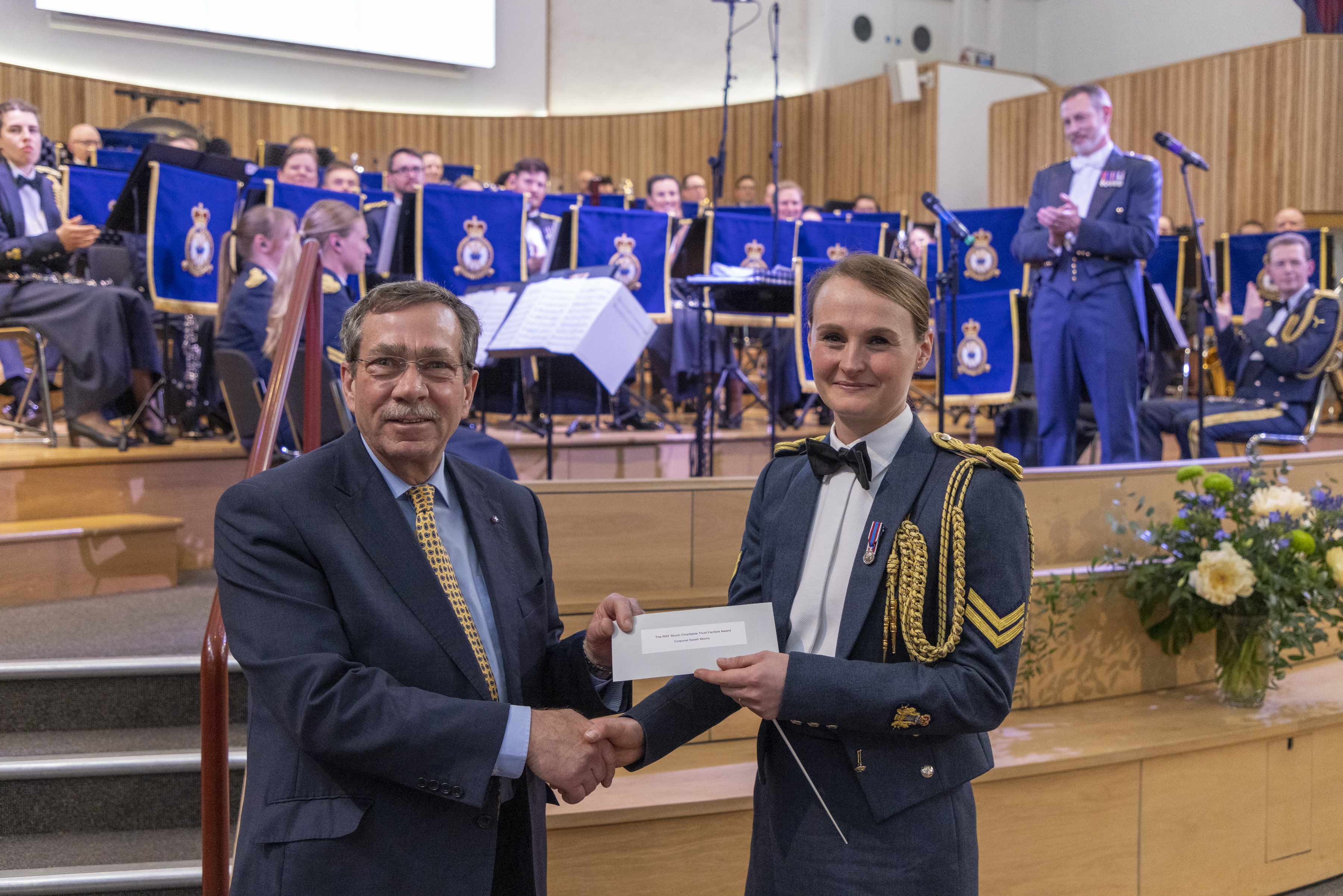 Malcolm Goodman MBE presenting Corporal Sarah Morris with the RAF Music Charitable Trust award for the best fanfare 