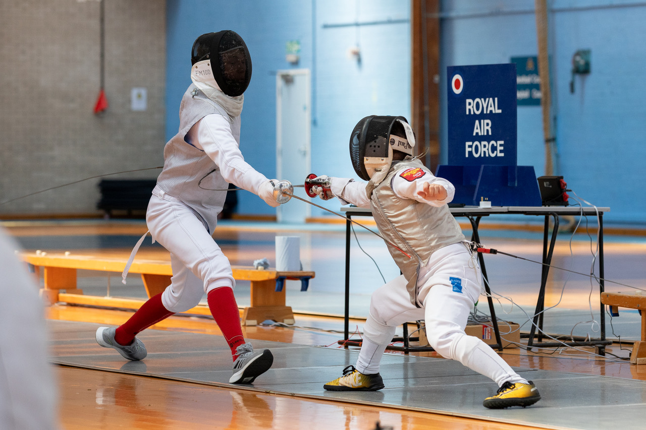 Two fencers in a duel.