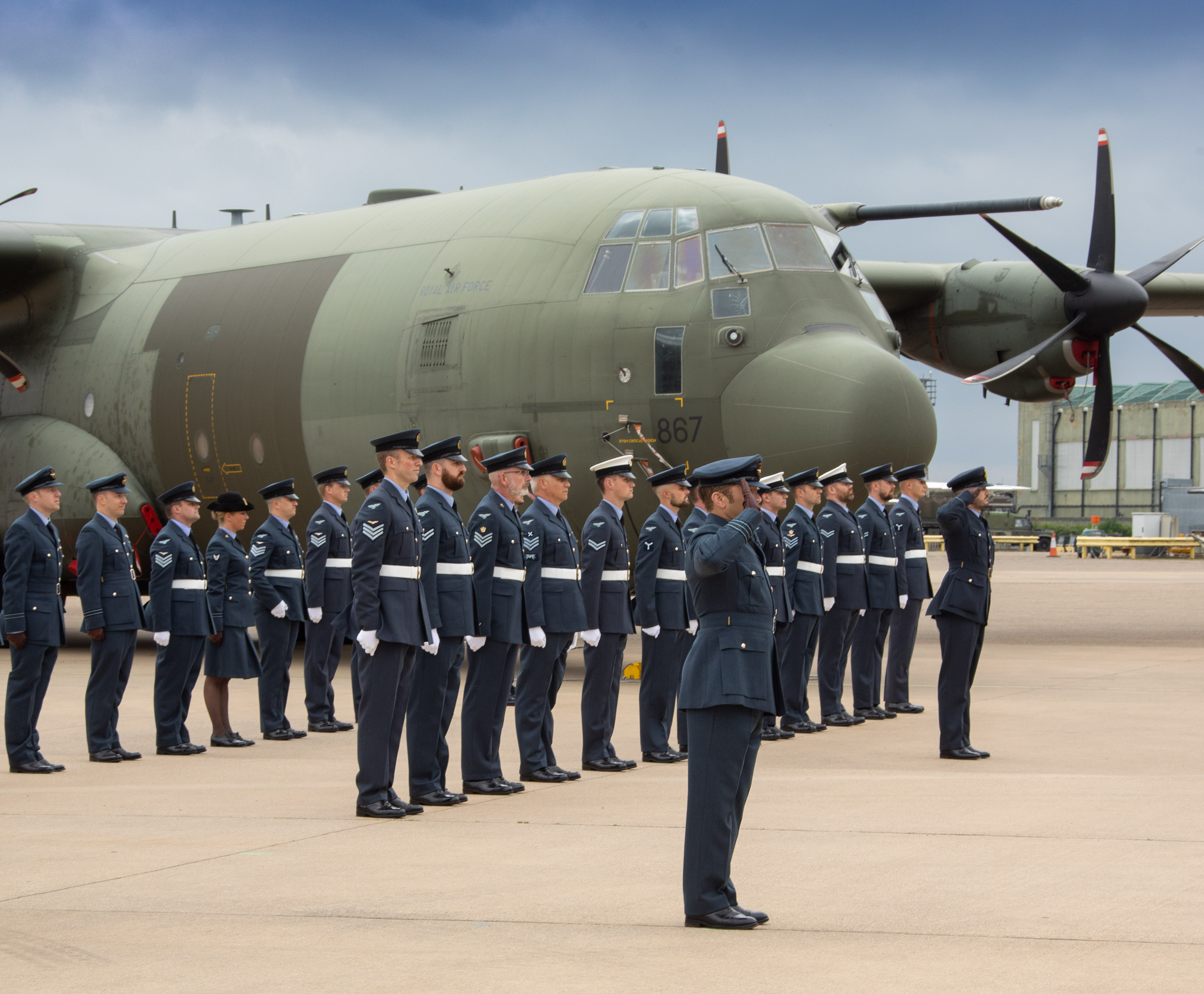 RAF Aviators stand and salute by Atlas aircraft.