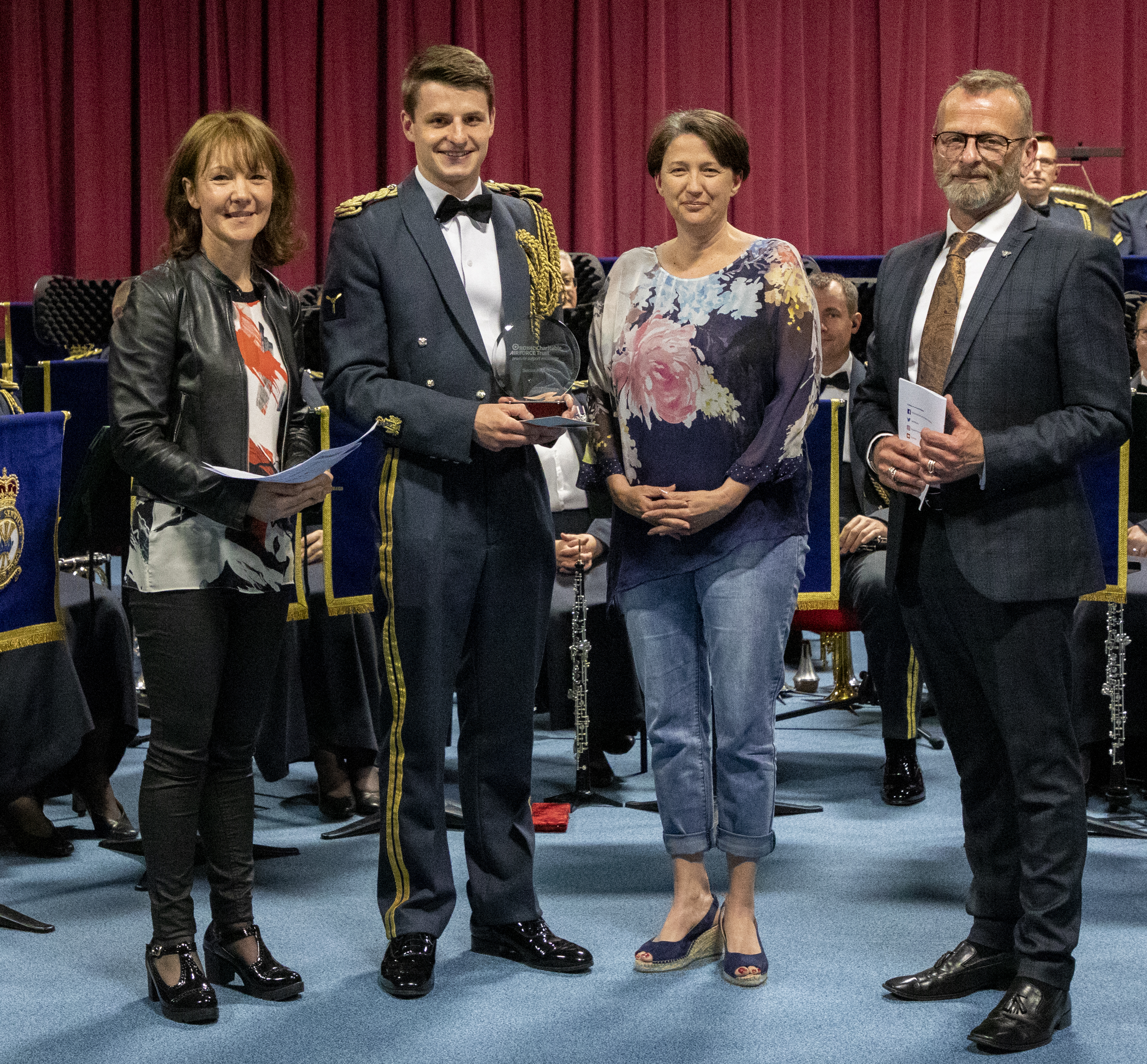 RAF Musician with Adjudicators, and Band in the background.