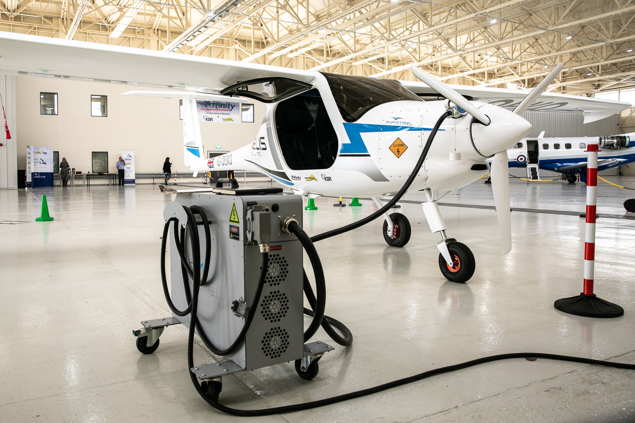Electric aircraft plugged into charging port.