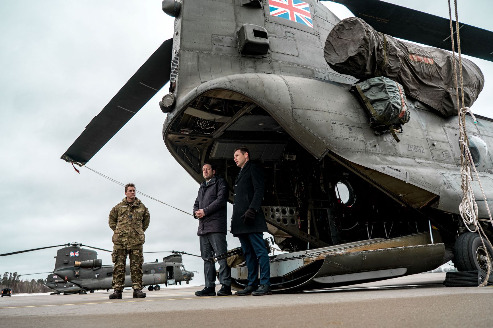 Image shows RAF aviators and Chinooks on the airfield.