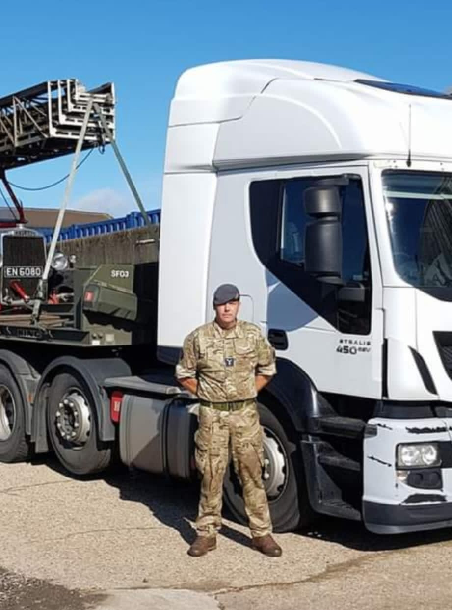 RAF Aviator stands by truck vehicle.