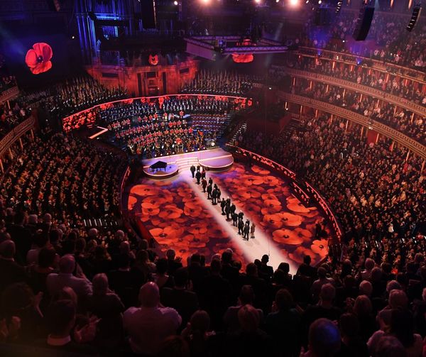 Audience gathered in the Royal Albert Hall; with lights and holographic Poppy's.