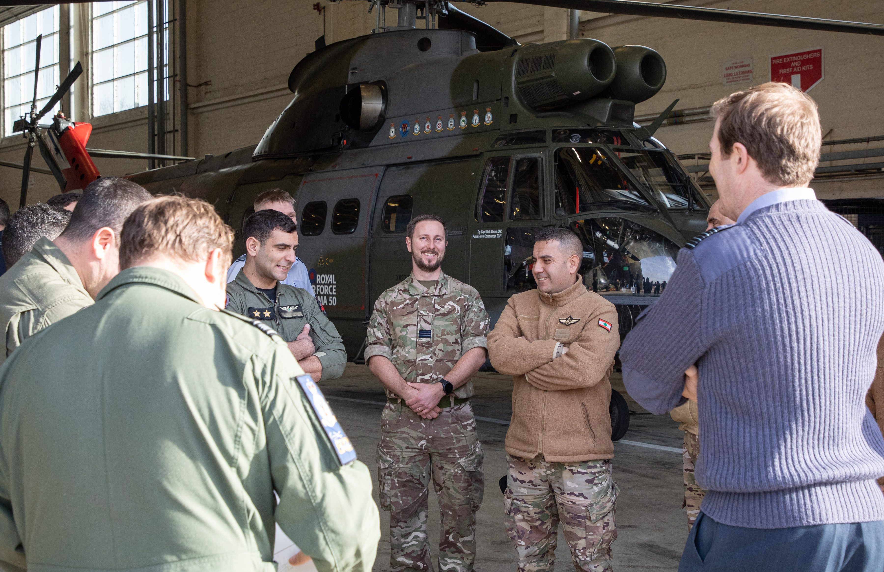 Personnel from both forces chat in the hangar