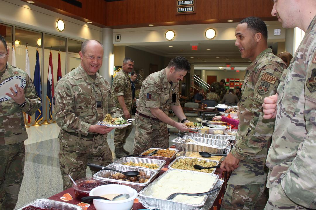 Image shows RAF aviators serving food to others in a messing facility.
