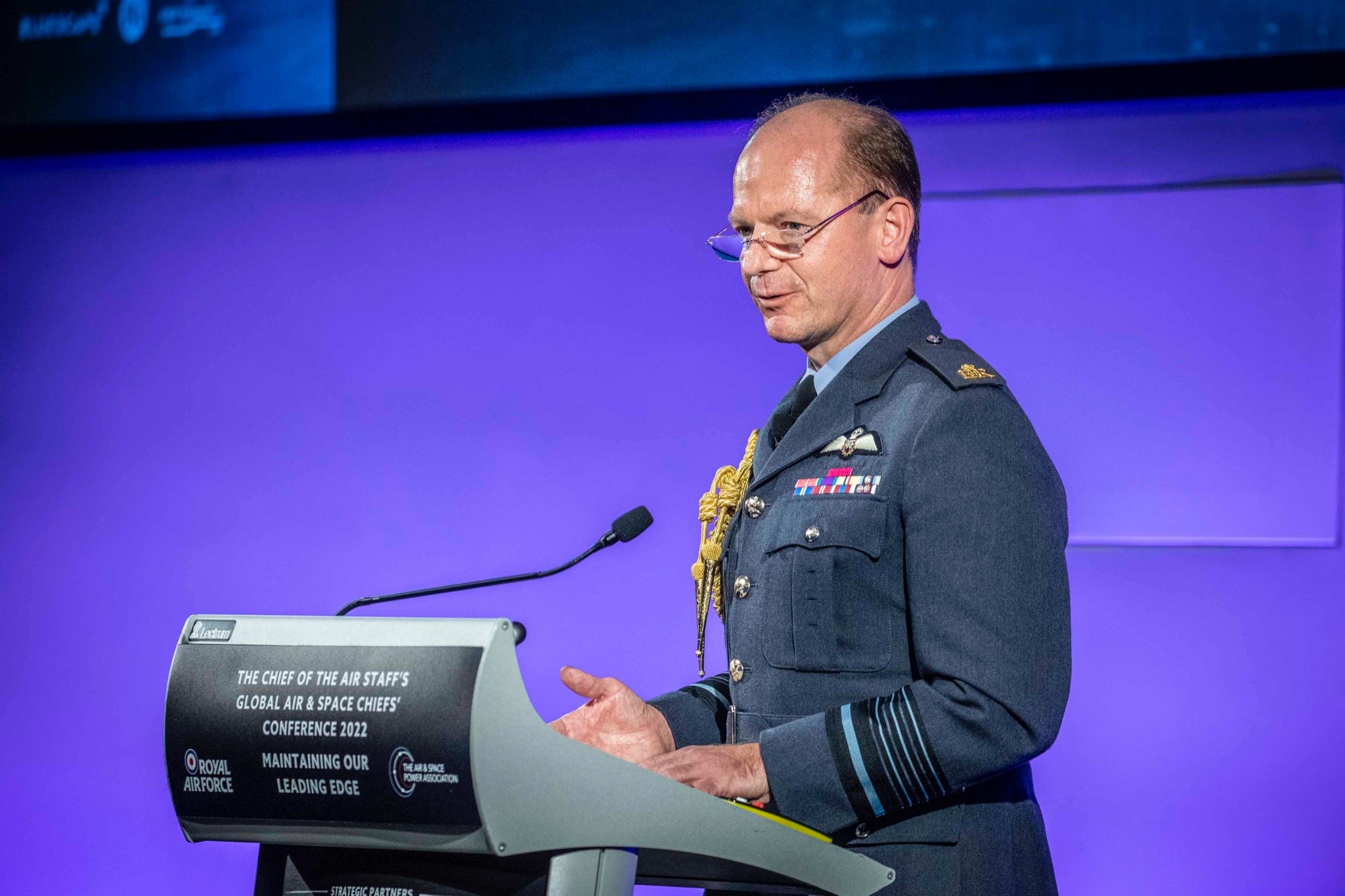 Image shows the Chief of the Air Staff giving speech at podium.