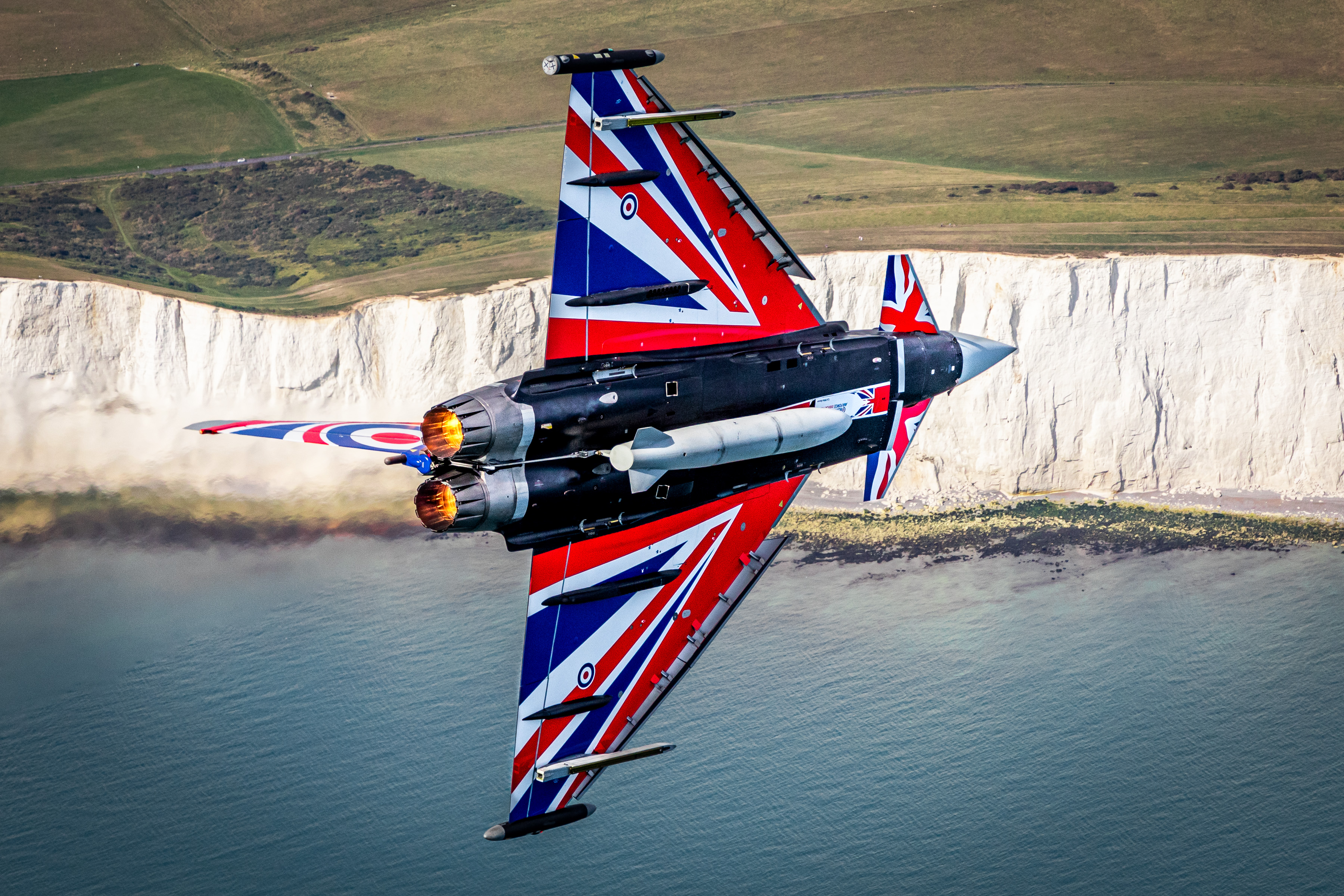 Image shows the Blackjack Typhoon flying over the white cliffs of Dover.