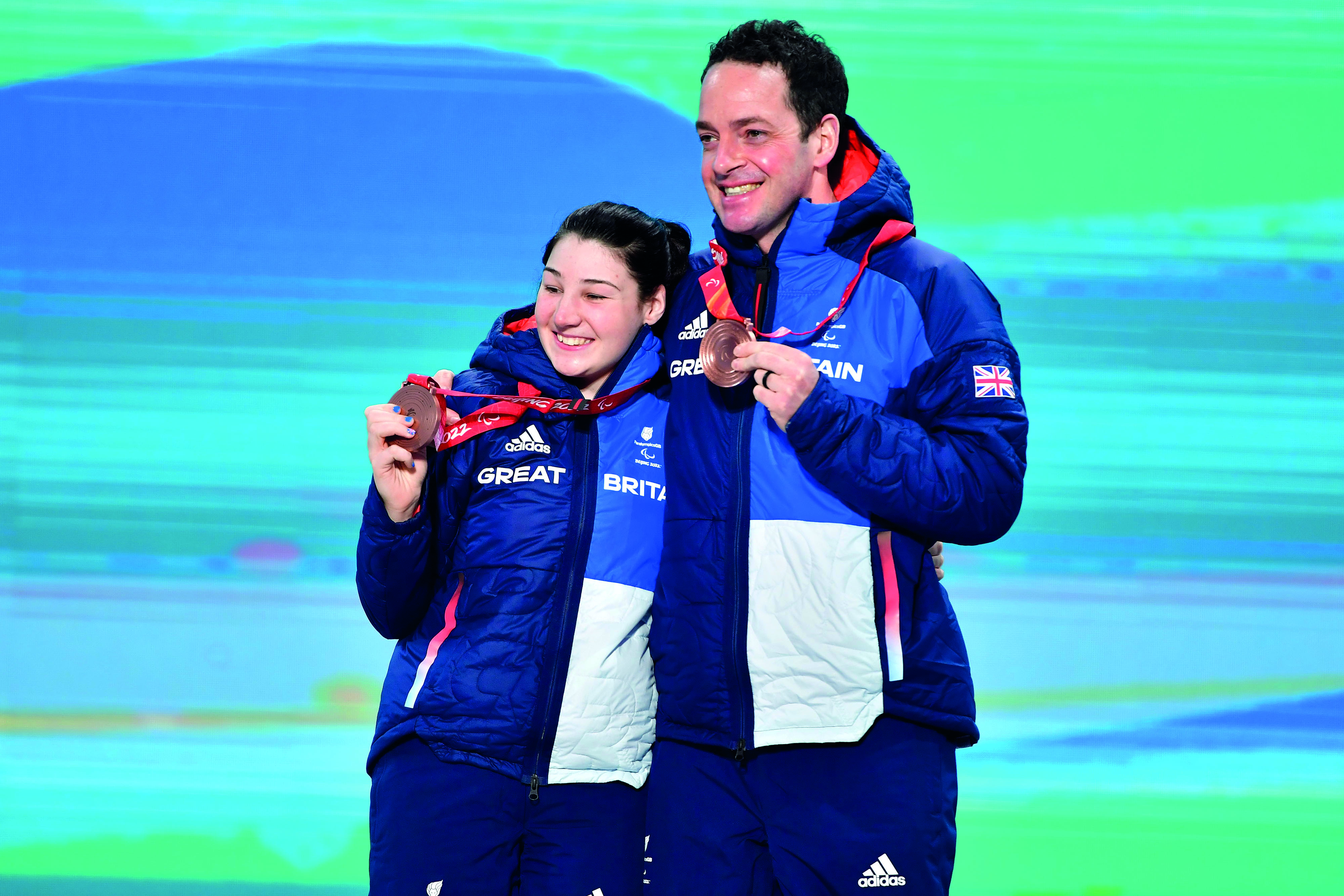 Gary and Menna hold their bronze medals.