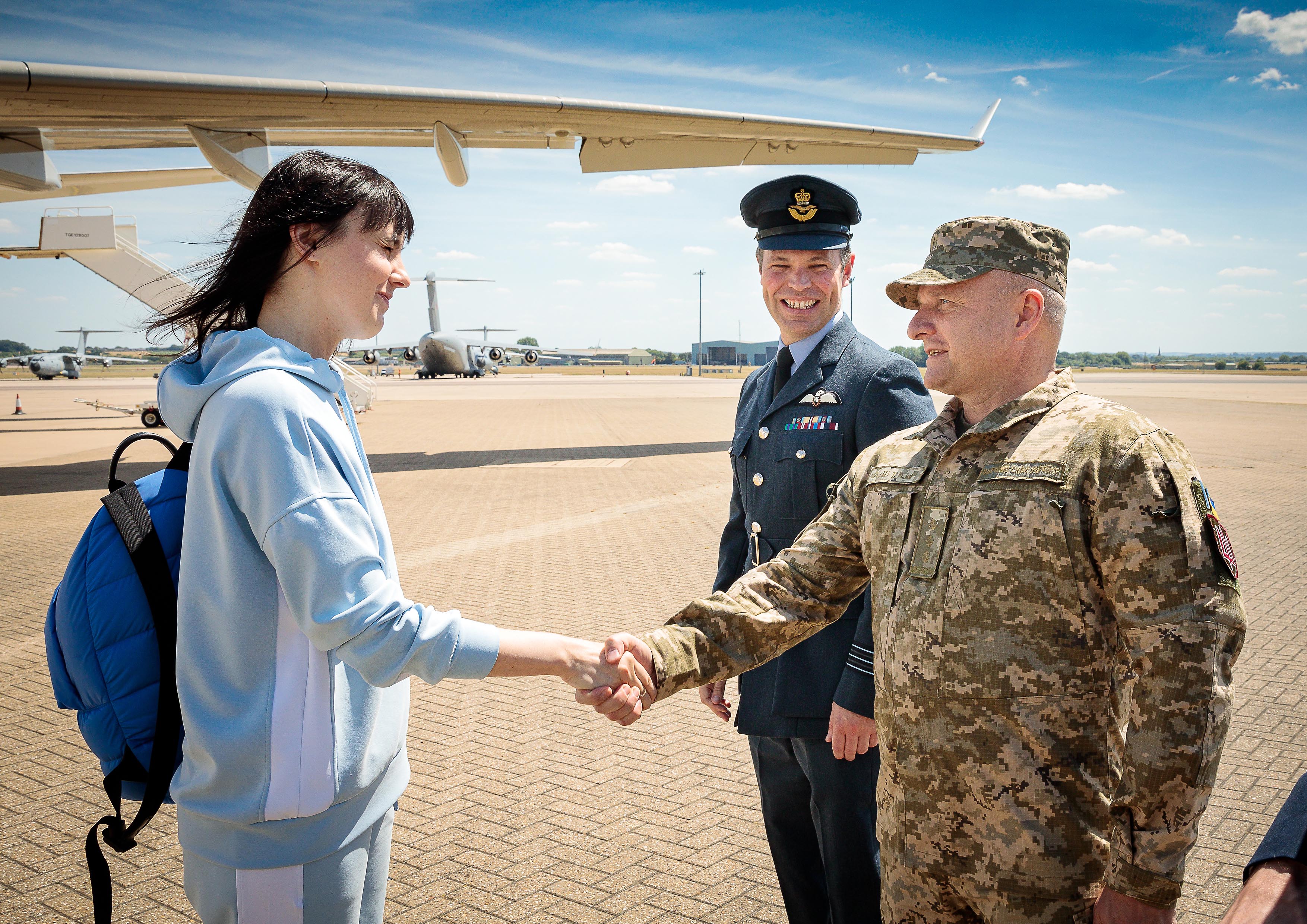 Image shows aviators shaking hands on the airfield.