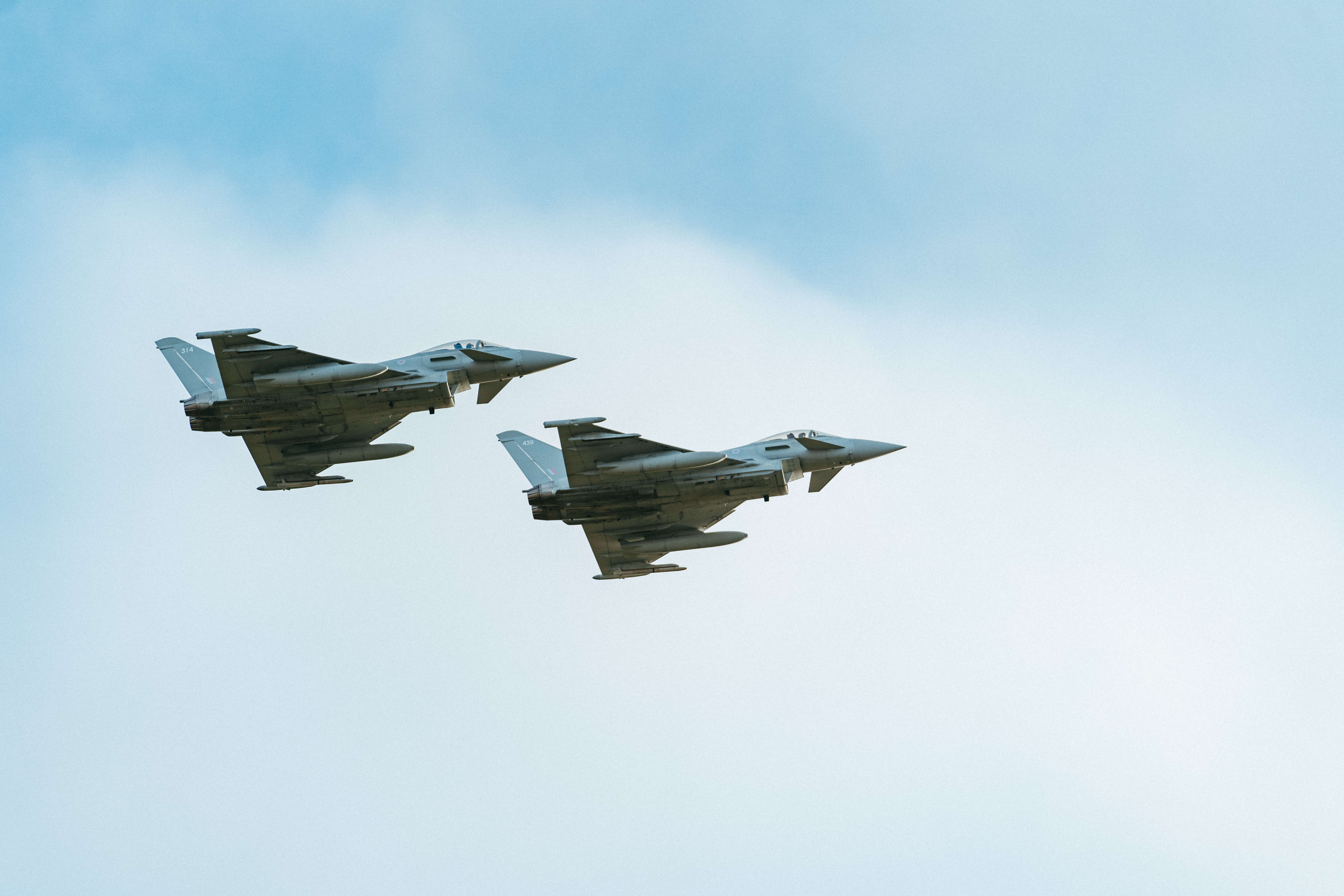 Image shows two RAF Typhoons in flight.