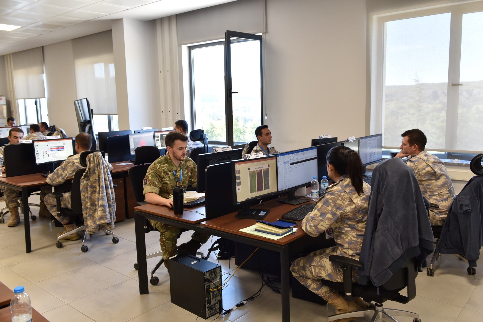 Image shows personnel sitting in an office.