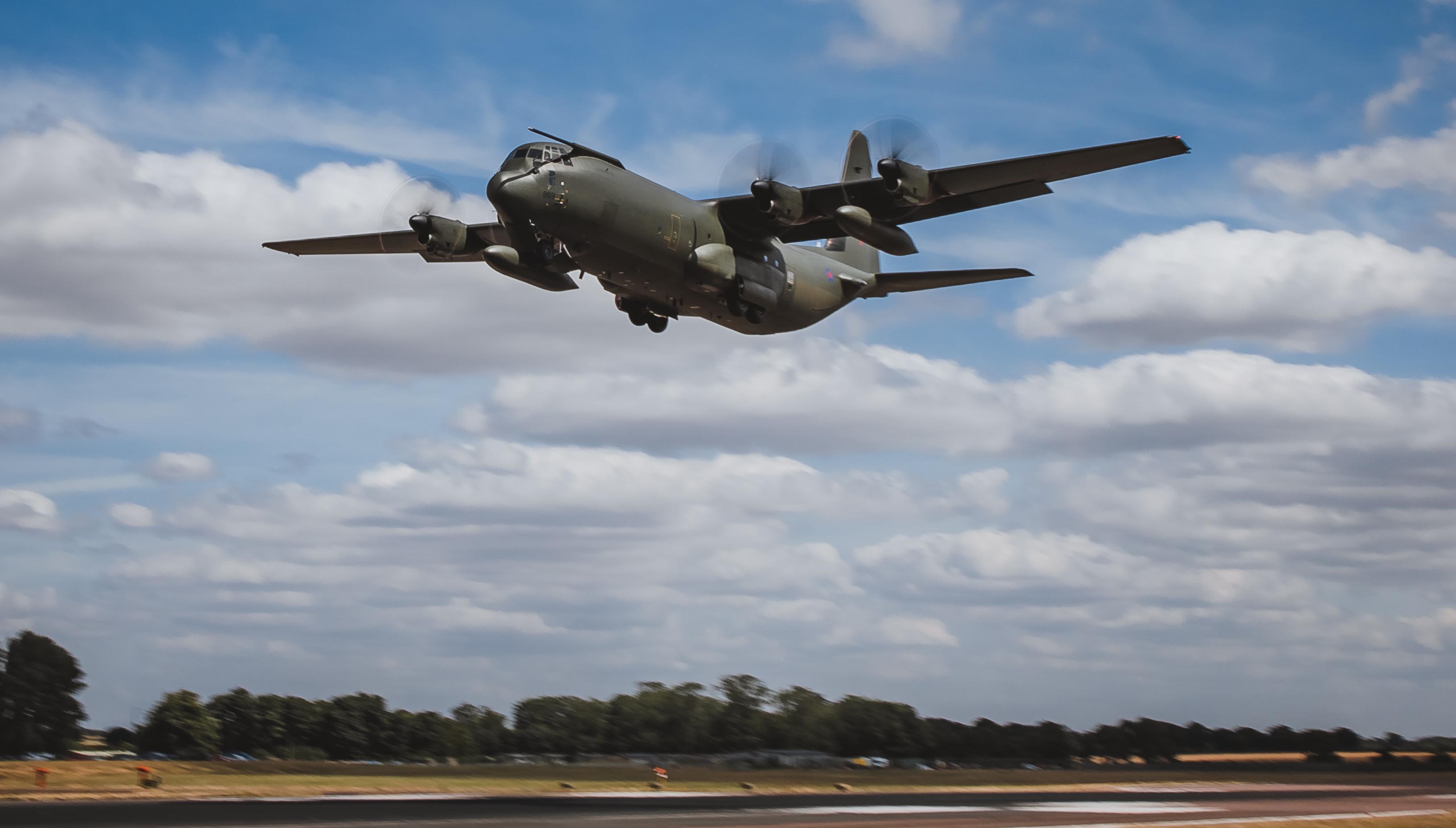 Image shows Hercules aircraft in flight.