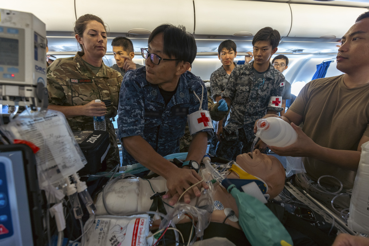 Japanese medics working with RAF Squadron Leader onboard RAF Voyager
